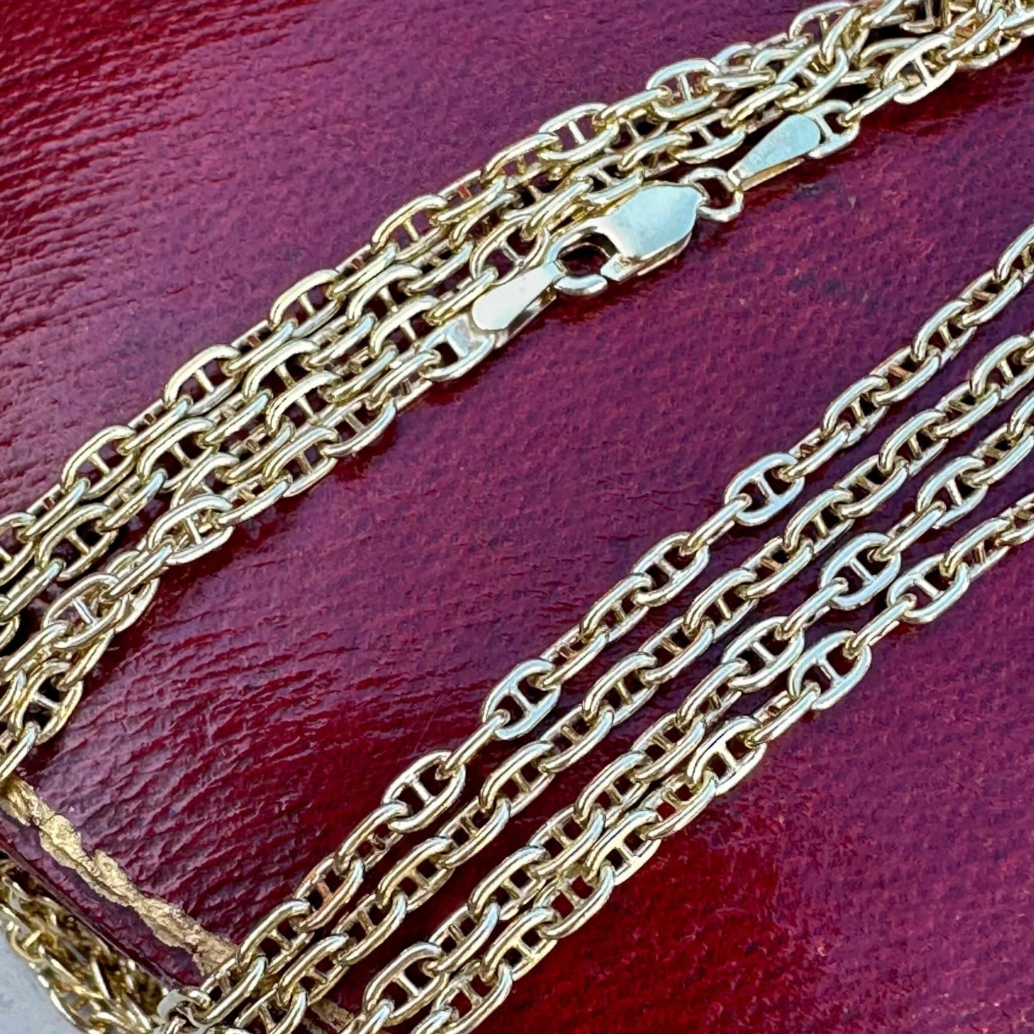 Gold Mariner Anchor Link Chain Necklace laying on red antique box