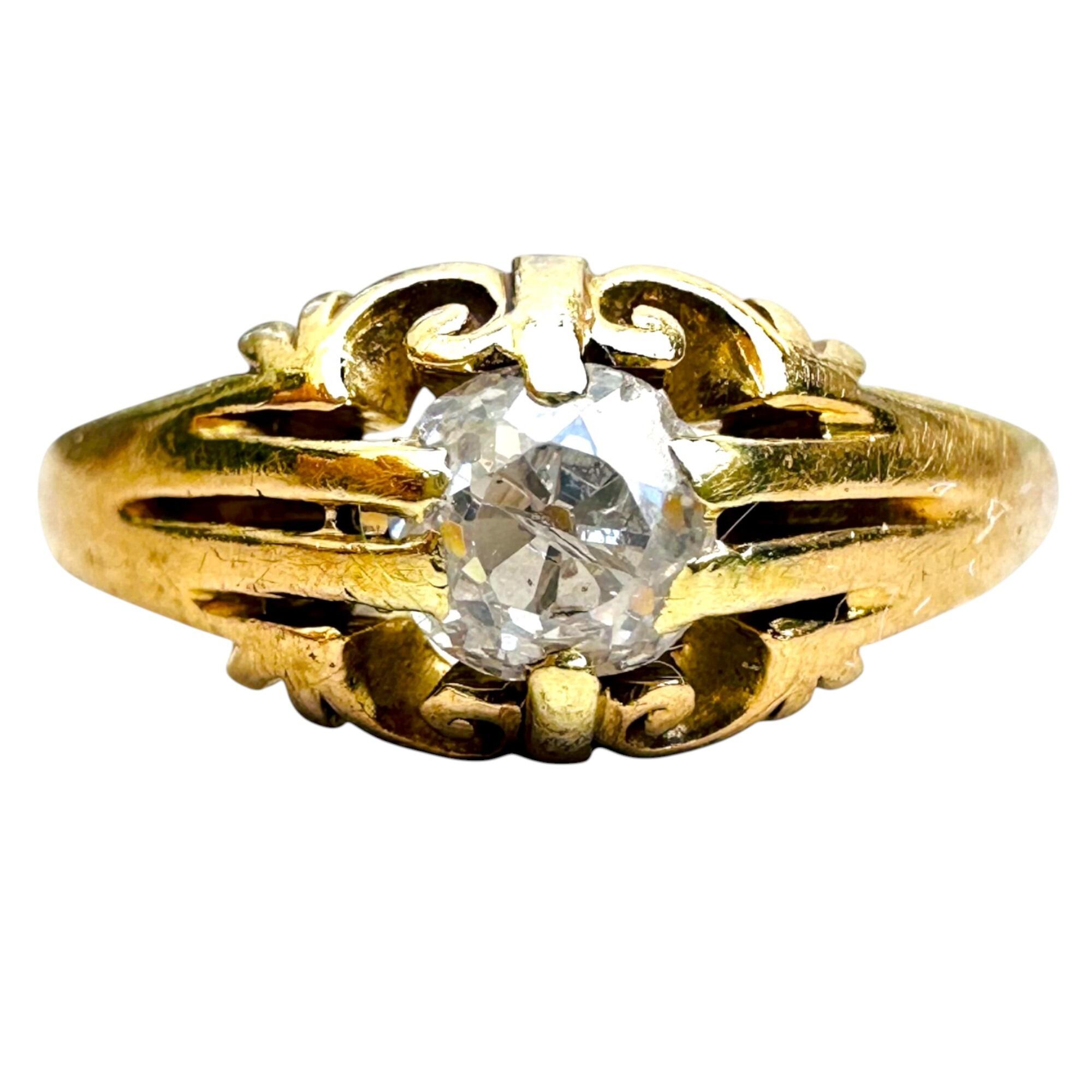 Antique 18k yellow gold old cut diamond gypsy ring on white background.
