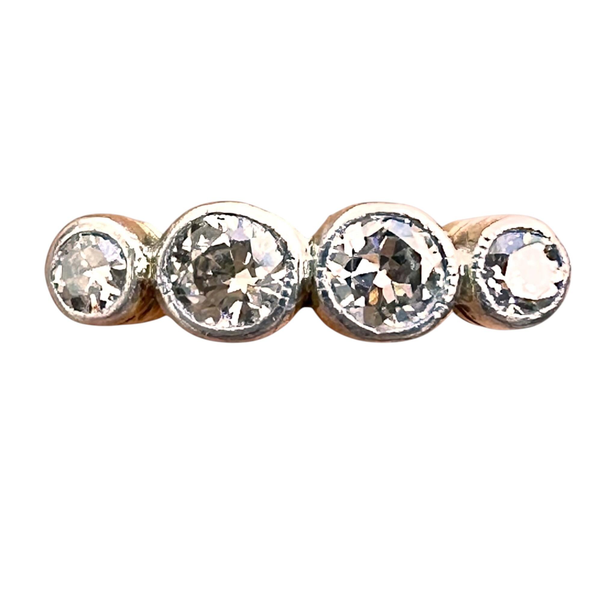 An elegant Art Deco 18k gold four-stone diamond engagement ring