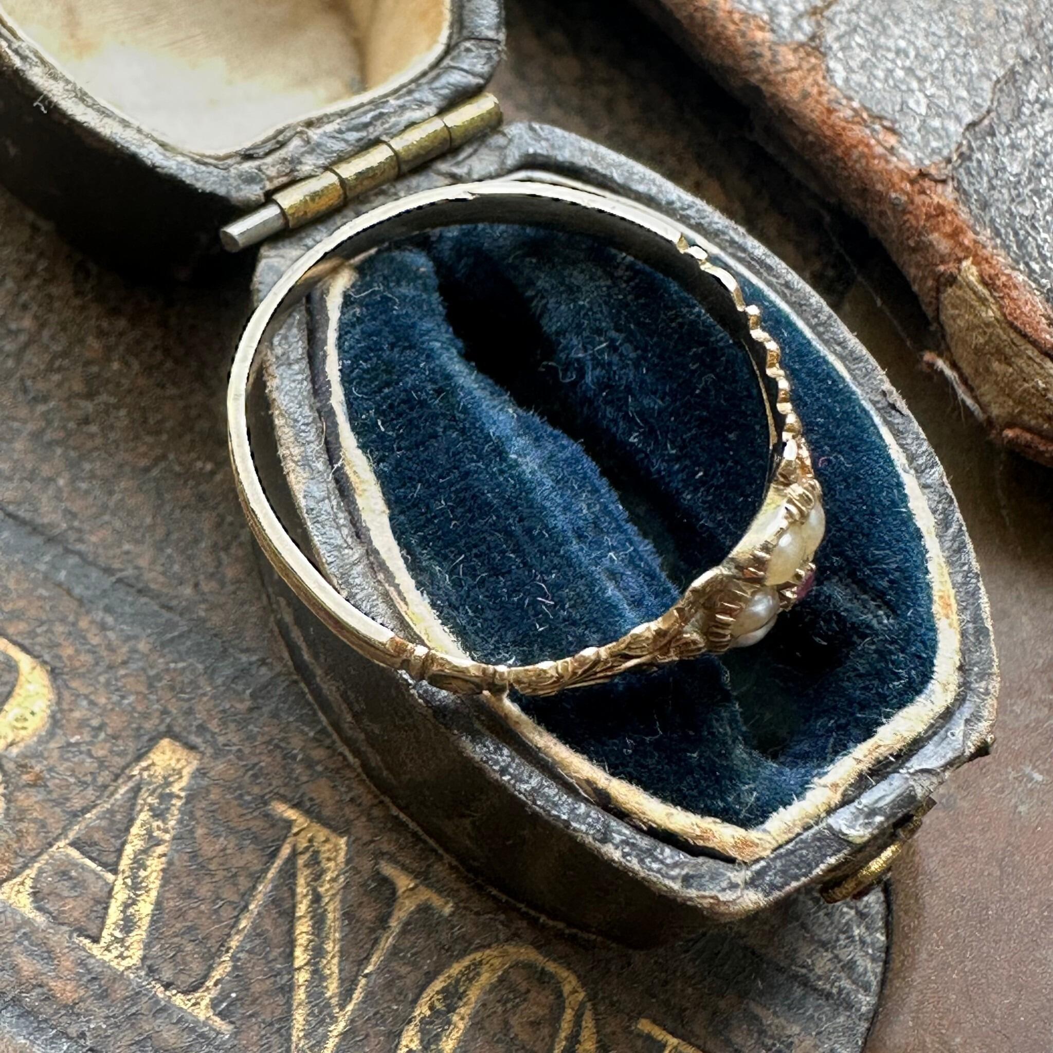side profile of Antique Georgian Regency Pearl & Ruby Daisy Ring displayed in antique box