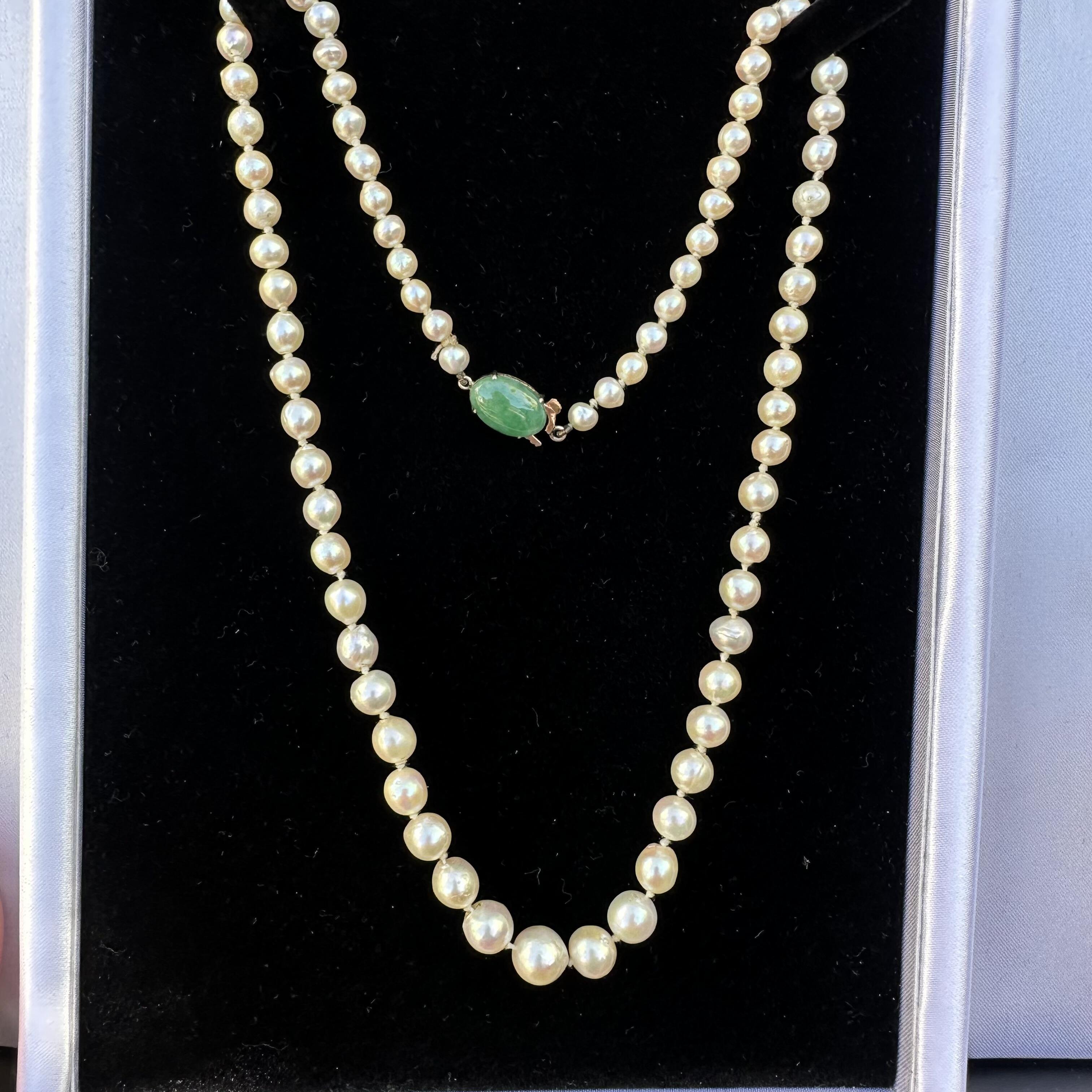 Antique Cultured Saltwater Baroque Pearl & 14k Gold Jadeite Clasp Necklace displayed on black velvet
