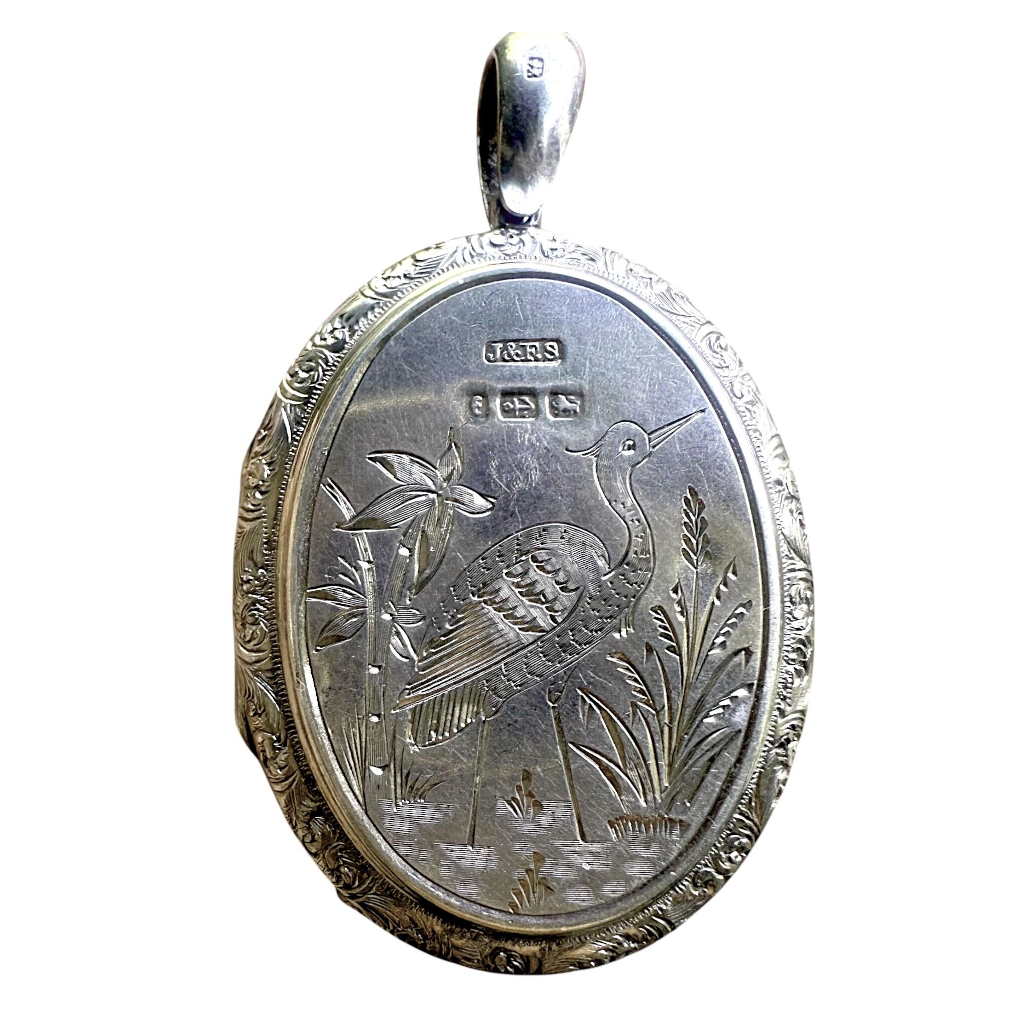Antique Victorian Silver Engraved Bird Locket Pendant with white background