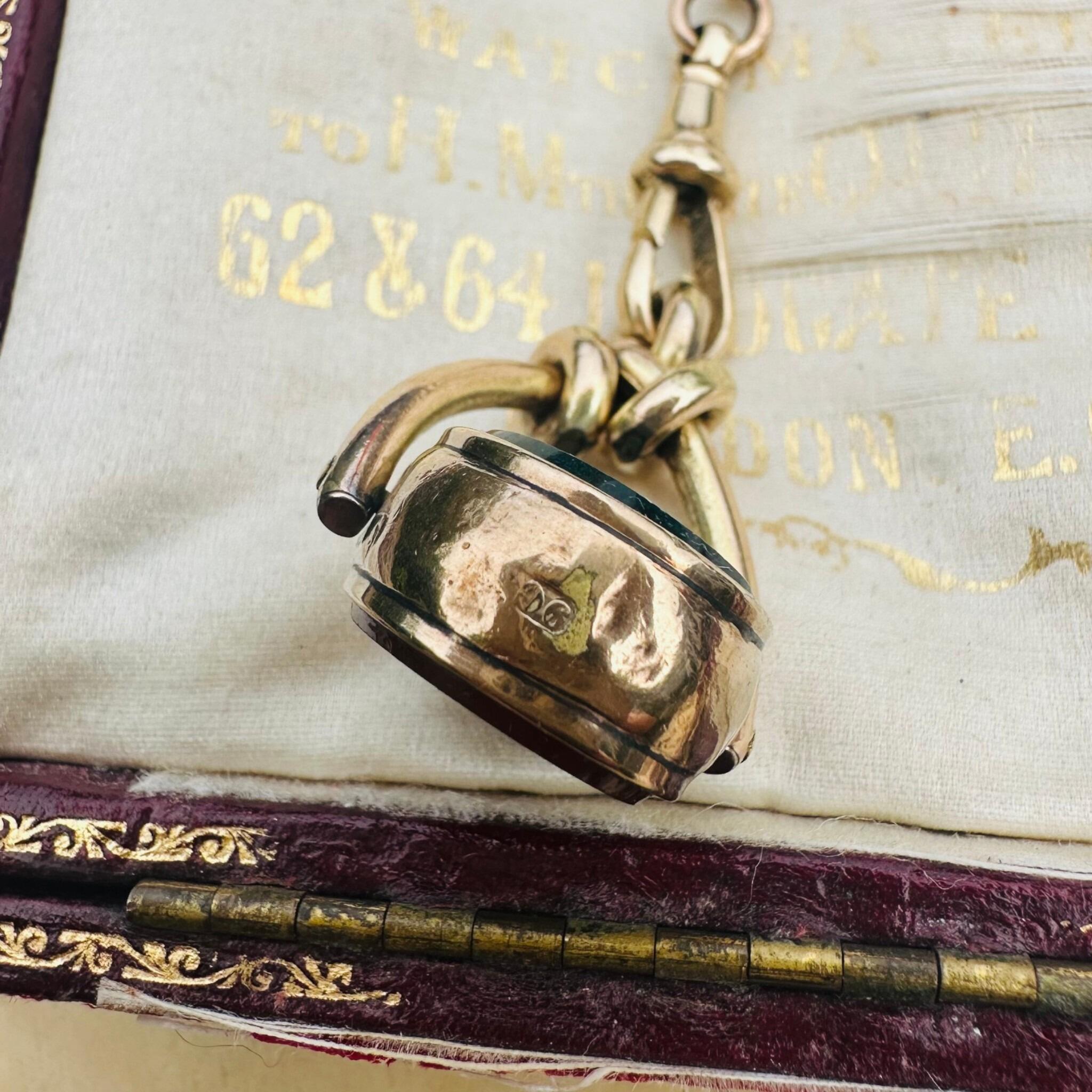 Antique Victorian 9ct Gold Bloodstone & Carnelian Swivel Fob displayed on antique box