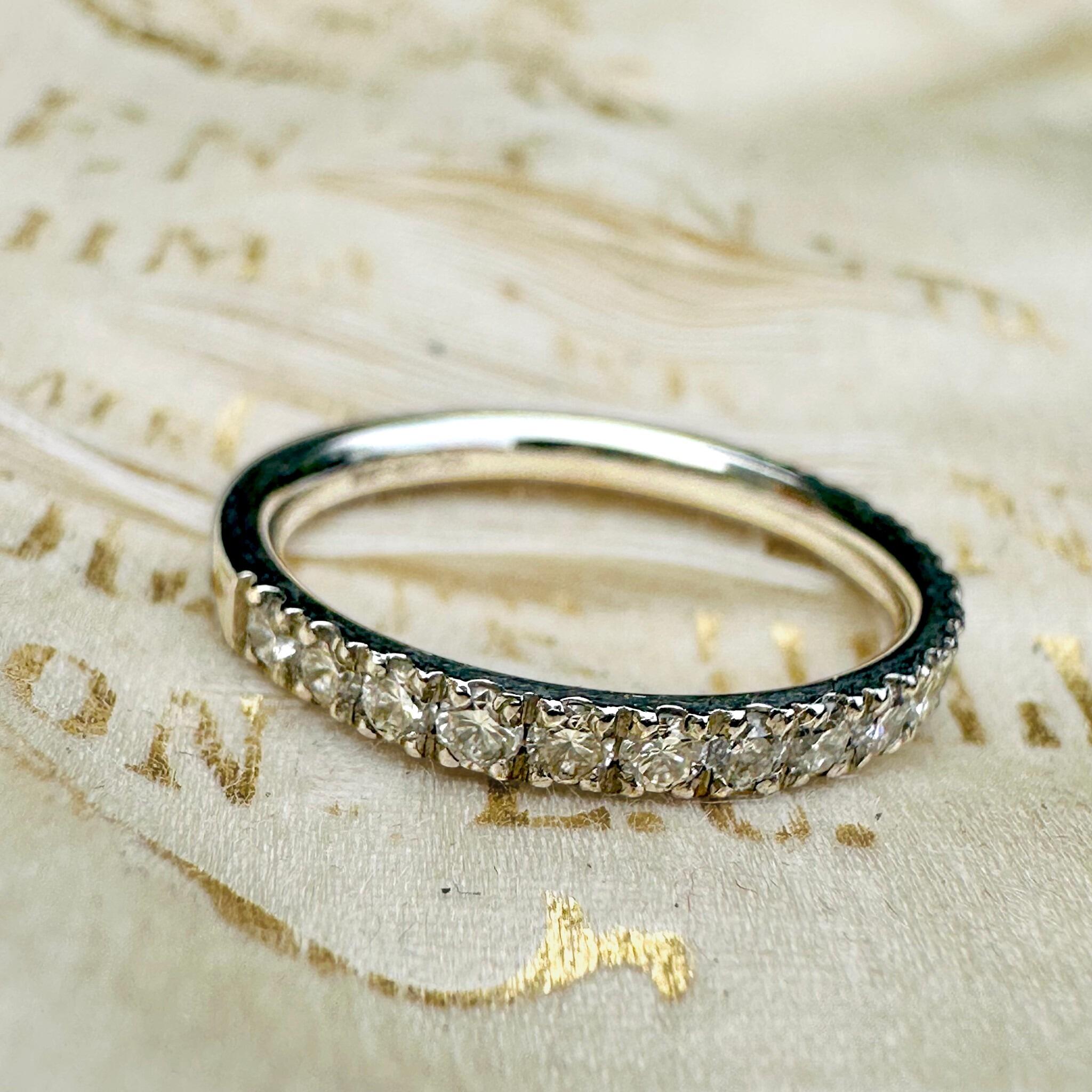 top view of Vintage Platinum & Diamond Band Ring laying on antique box