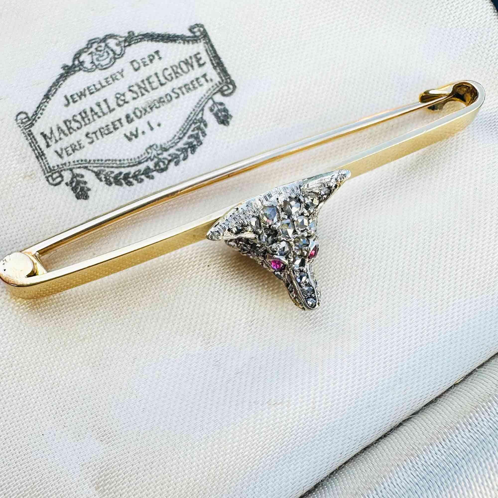 Side view of Antique diamond fox head brooch with rose cut diamonds, ruby eyes, and gold teeth detail
