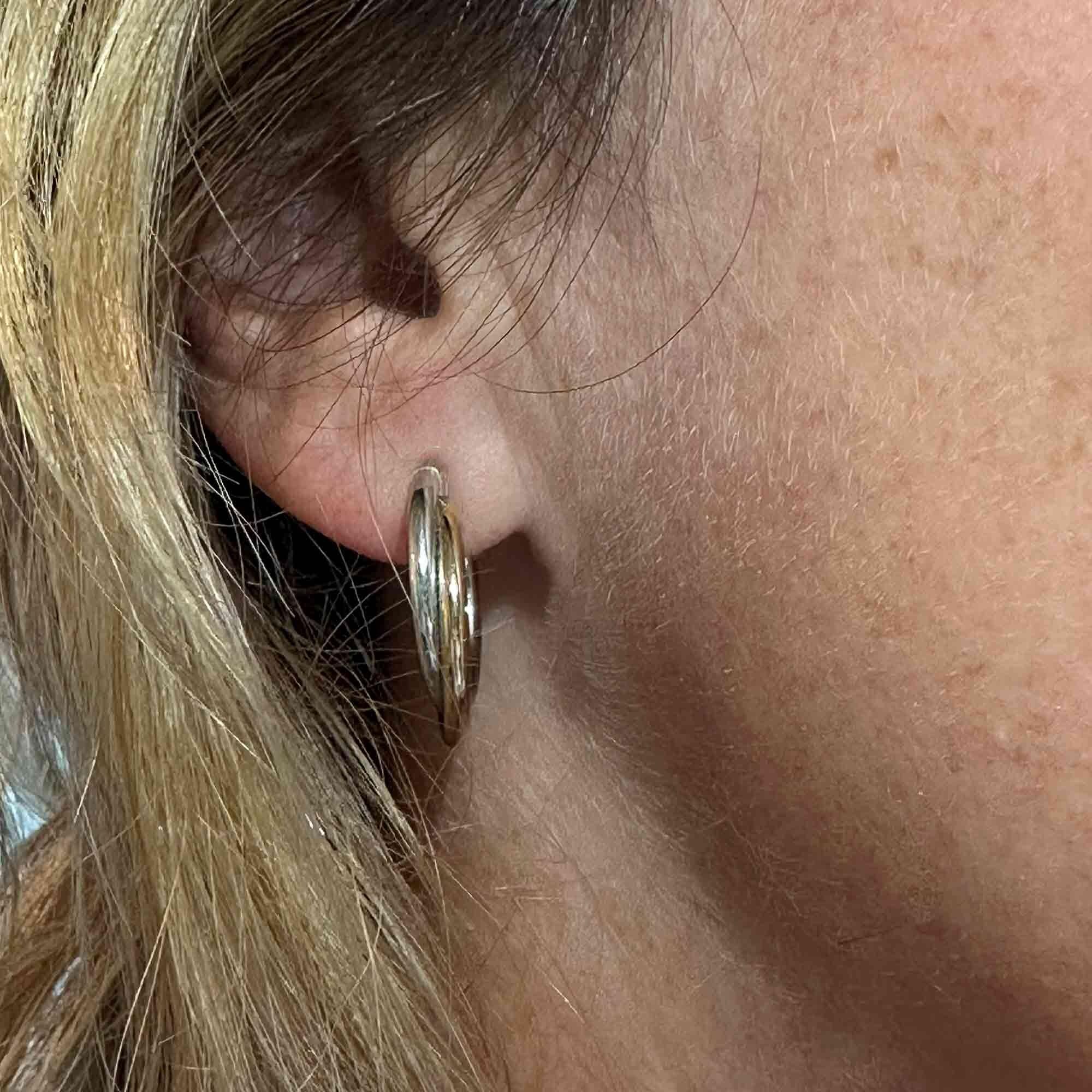 Italian bi-colour 9ct gold hoop earrings worn on model.