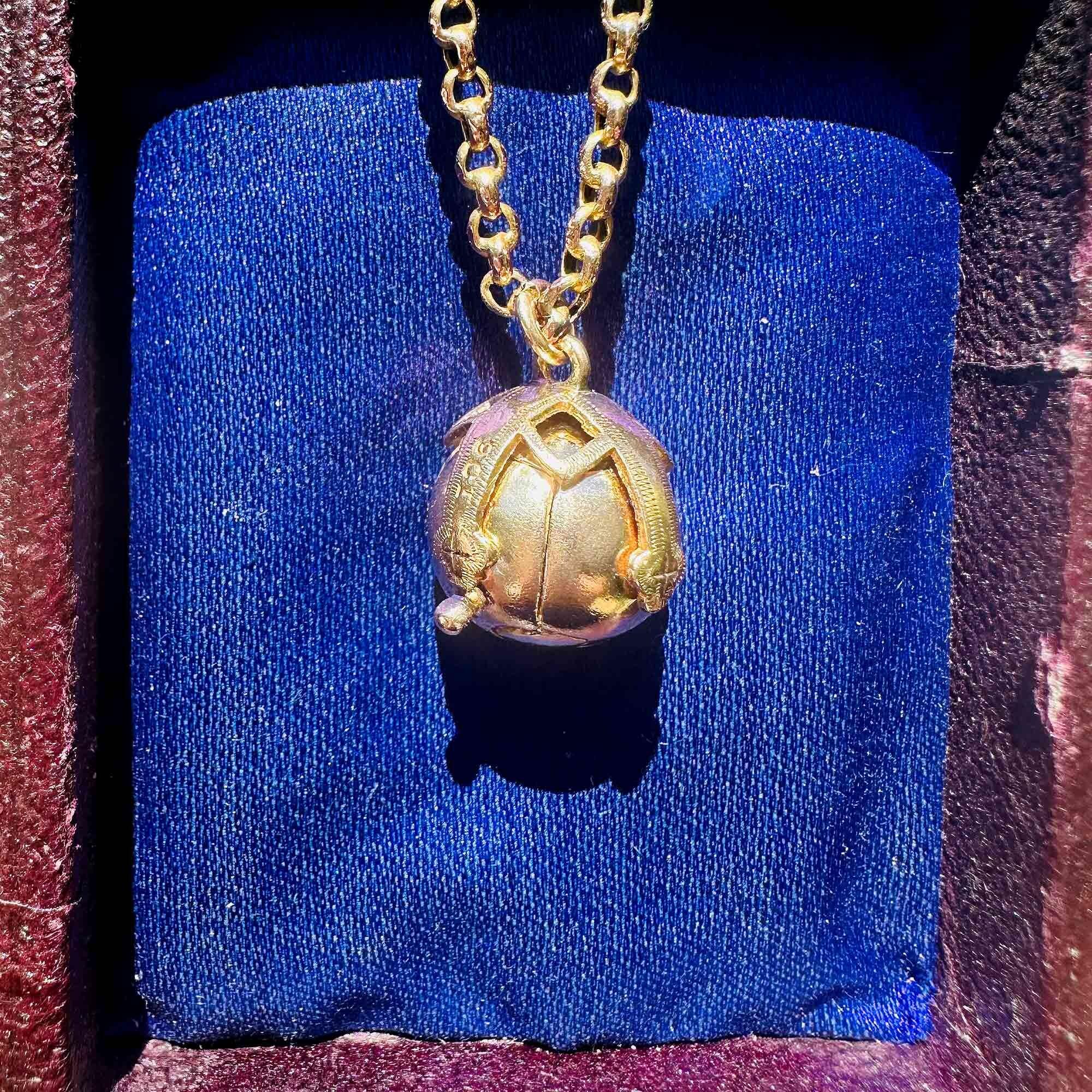 antique 9k rose gold masonic orb pendant on antique box.