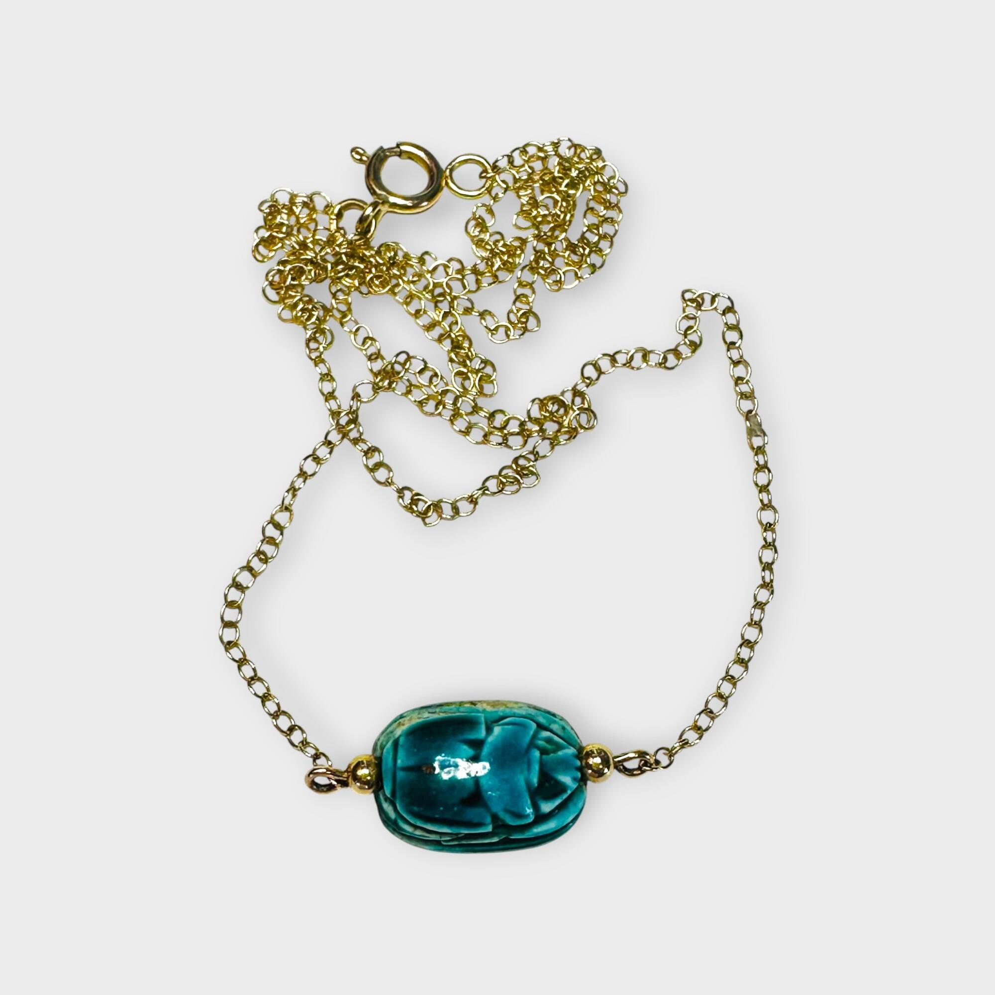 9k Gold Blue Faience Scarab Necklace – Egyptian Revival Pendant, grey background.