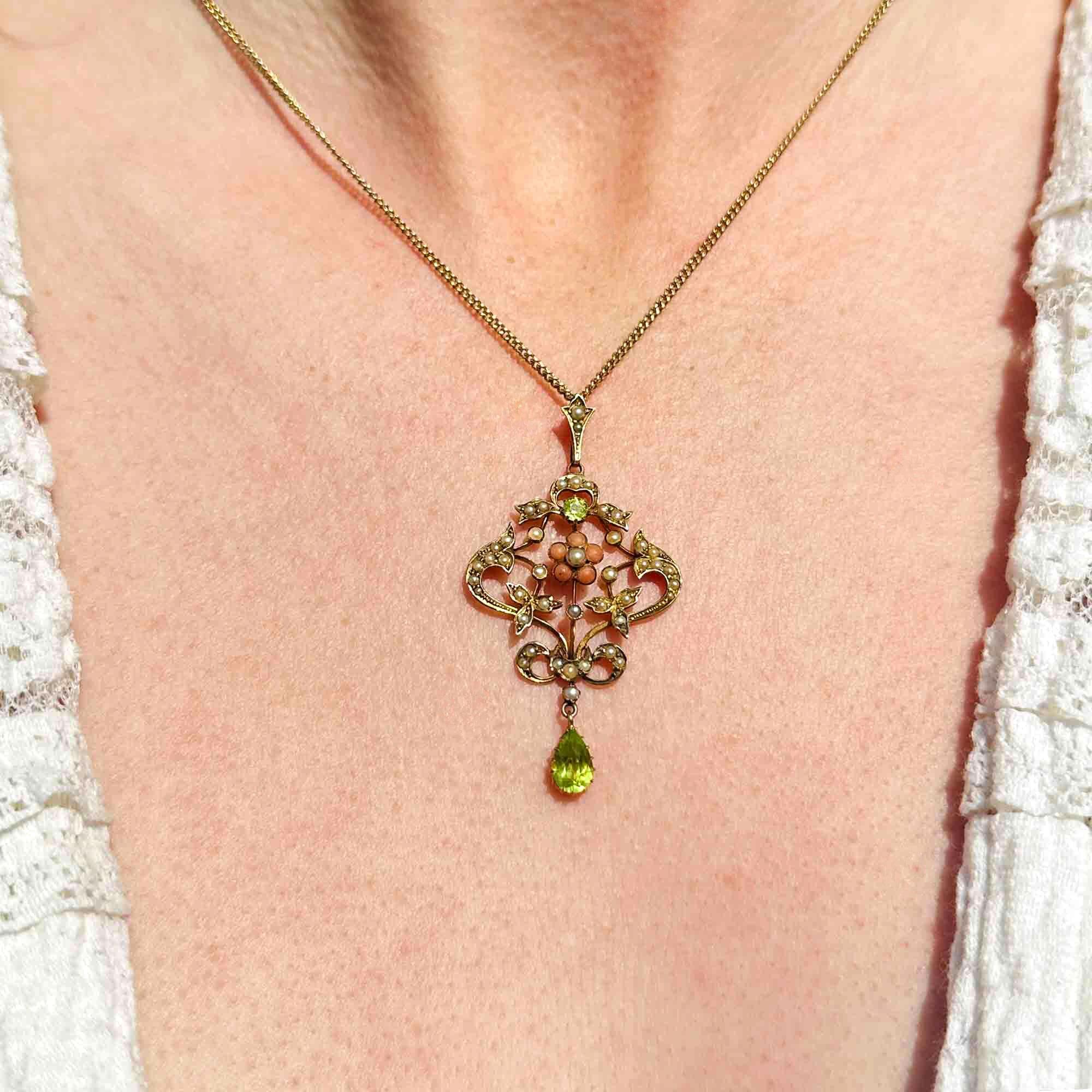 Art Nouveau 9k gold Lavaliere Pendant Peridot & Pearl Floral Motif, displayed on models neck