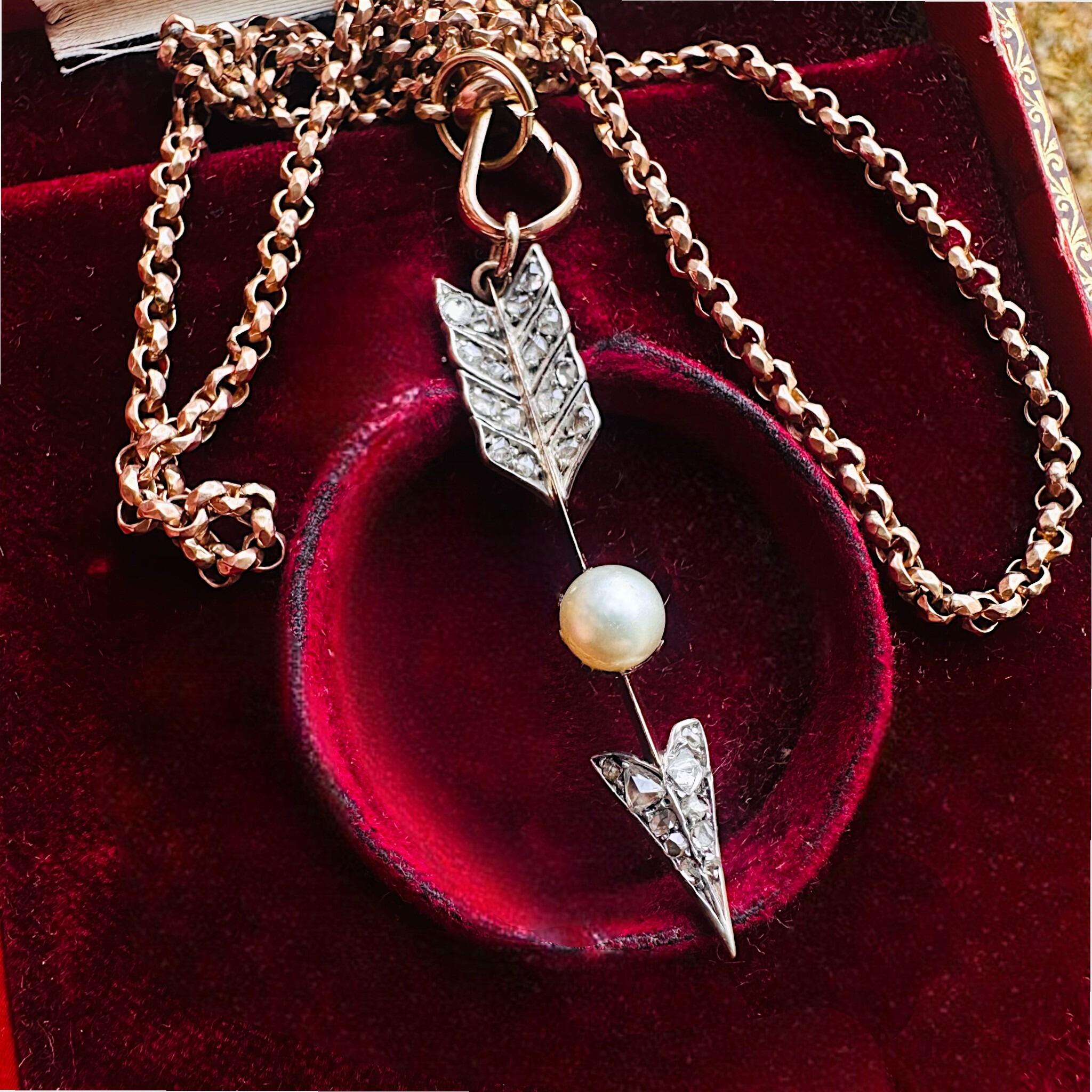 Victorian Rose Cut Diamond & Pearl Cupid’s Arrow Pendant displayed on red velvet