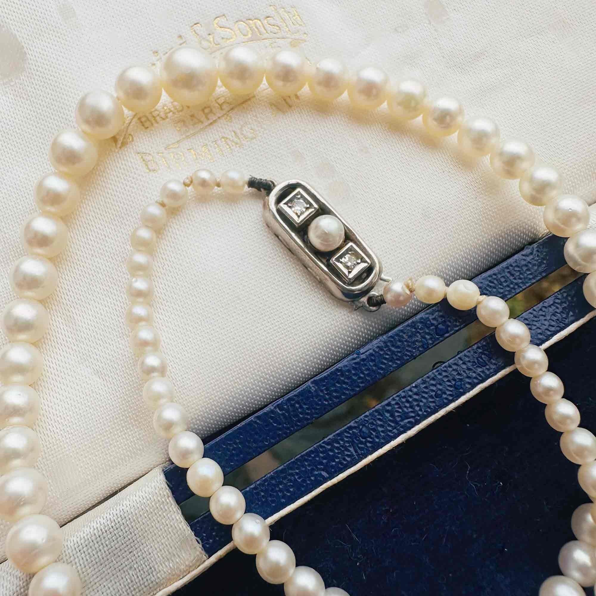 Saltwater Cultured Pearl & 14ct White Gold Diamond Clasp Necklace, displayed on antique box.
