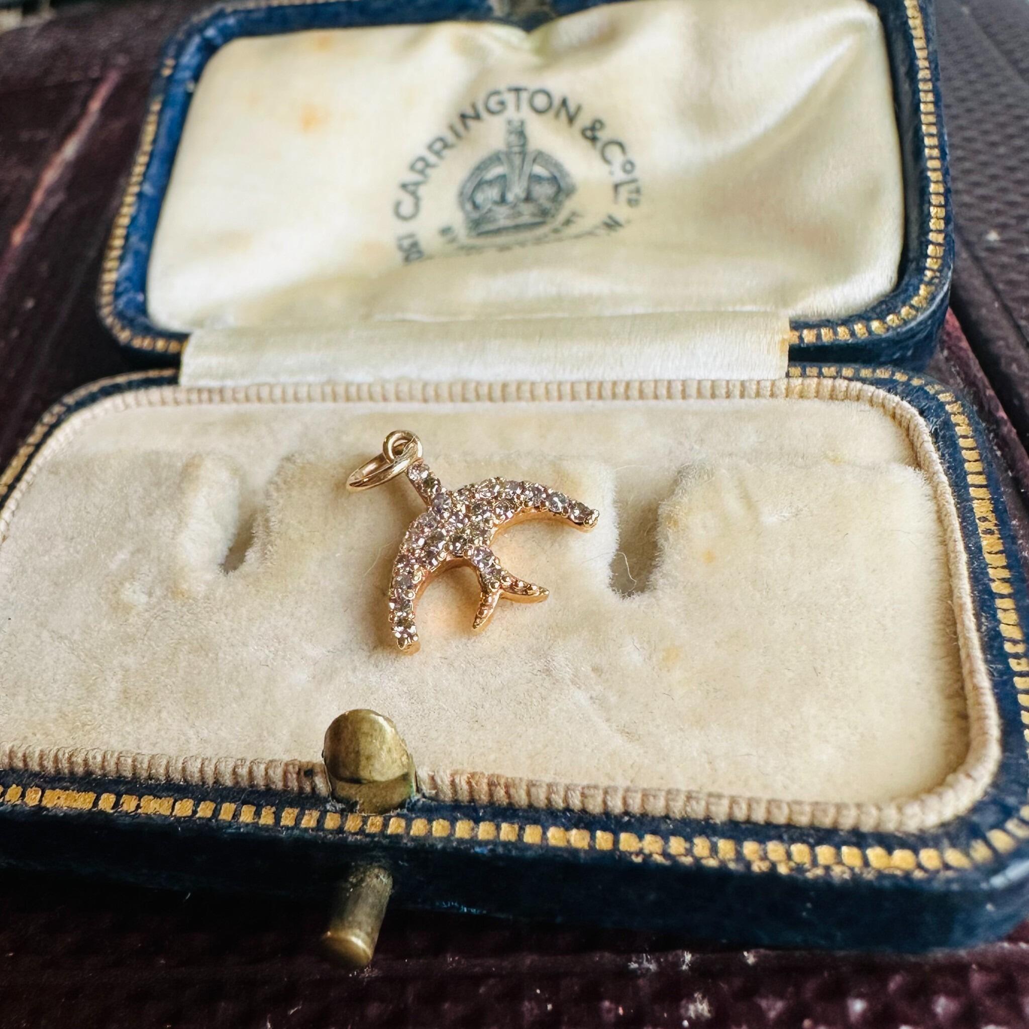 14ct Rose Gold & Diamond Swallow Charm Pendant, displayed on antique box