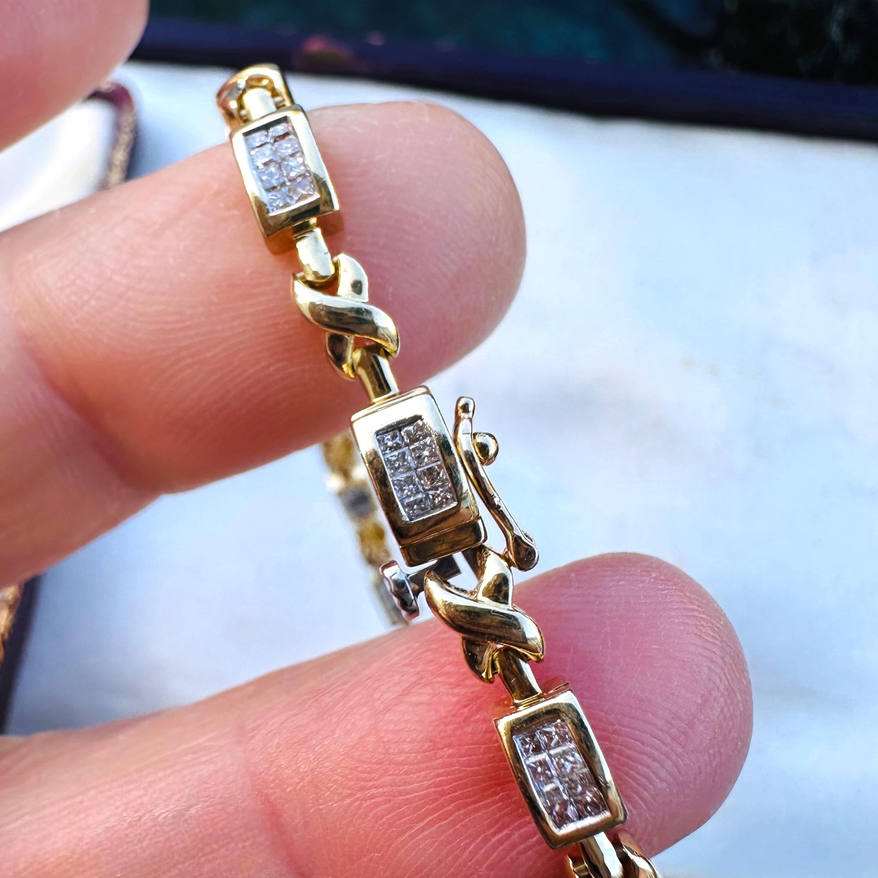 14k Gold Princess Cut Diamond Tennis Bracelet held in models fingers.