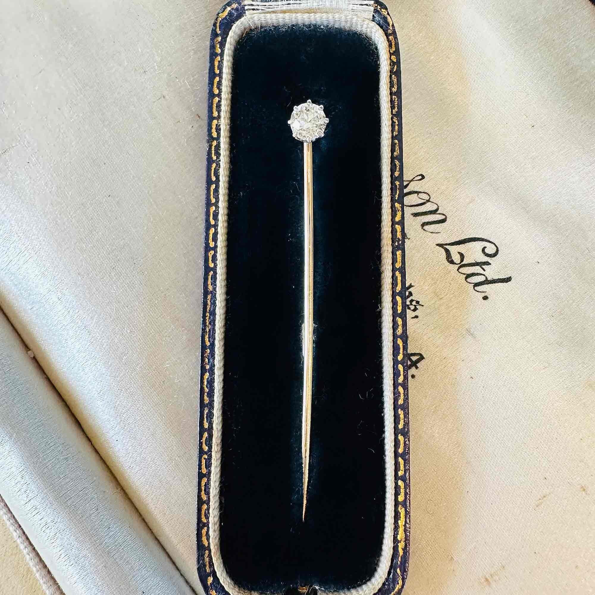 Edwardian 0.48ct Old European Cut Diamond Stick Pin & Original Box laying on other antique boxes