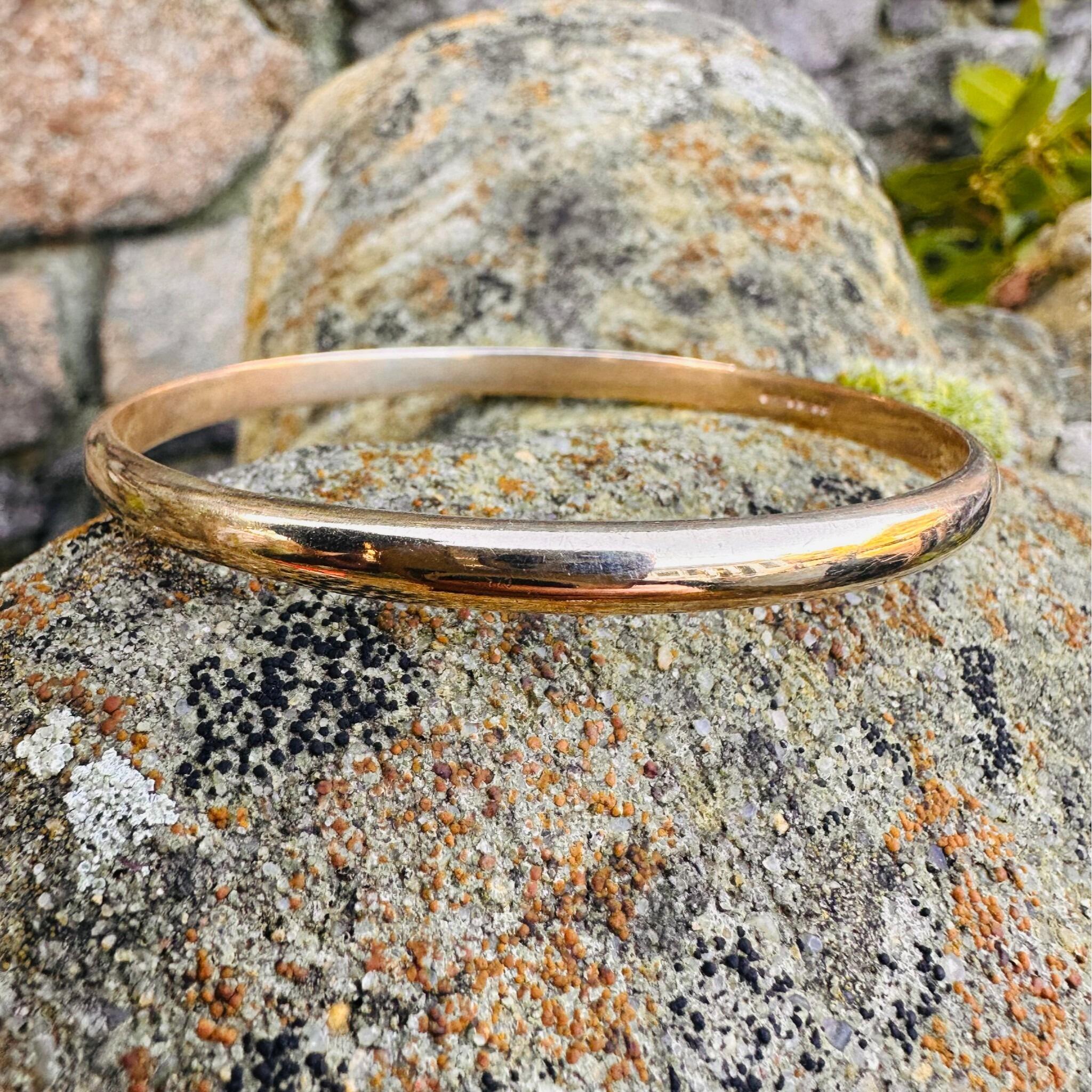 9ct Solid Gold D Shaped Bangle, Charles Green & Sons 1987 Hallmarked displayed on textured stone
