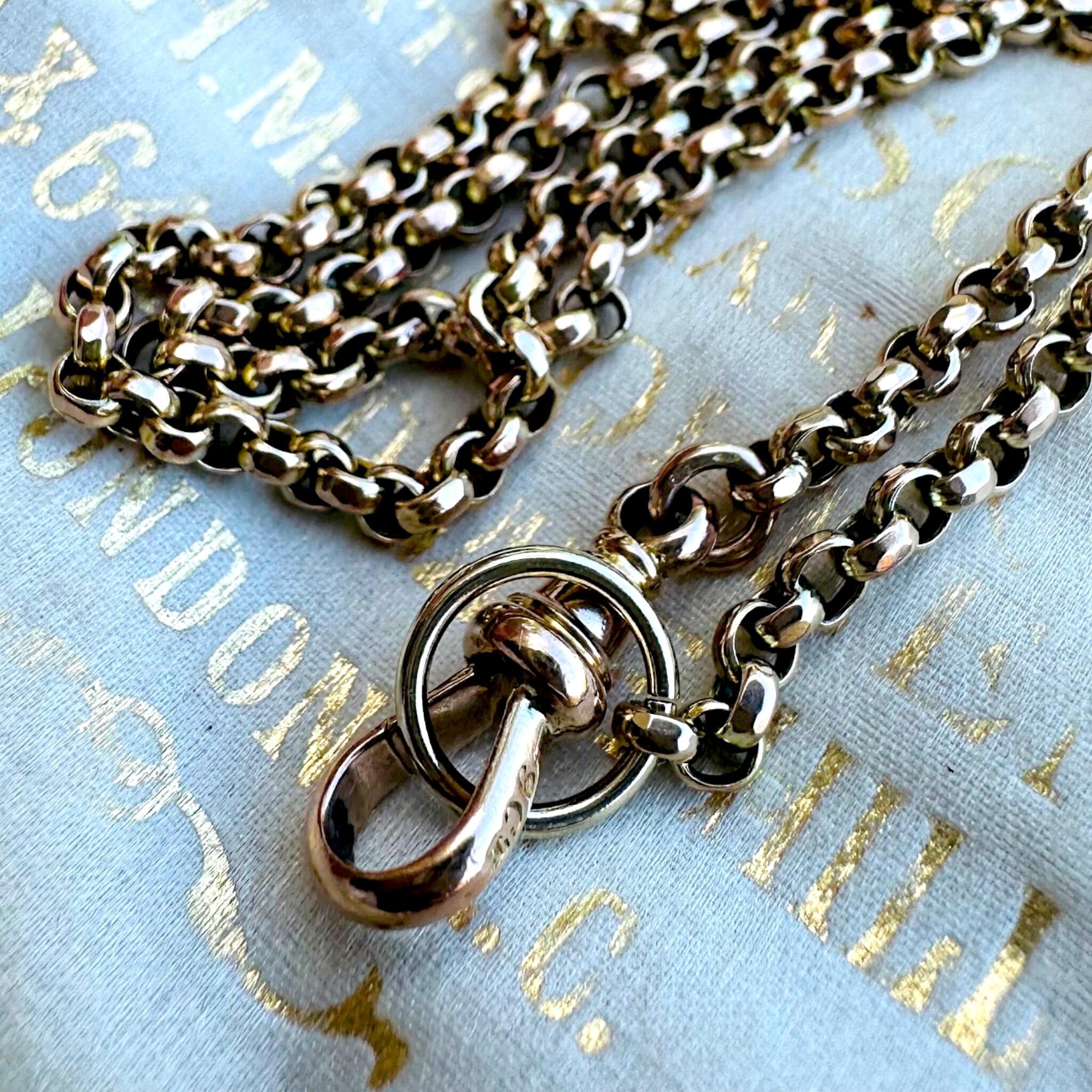close up of Antique Gold Belcher Link Chain Necklace & Dog Clip displayed on antique box