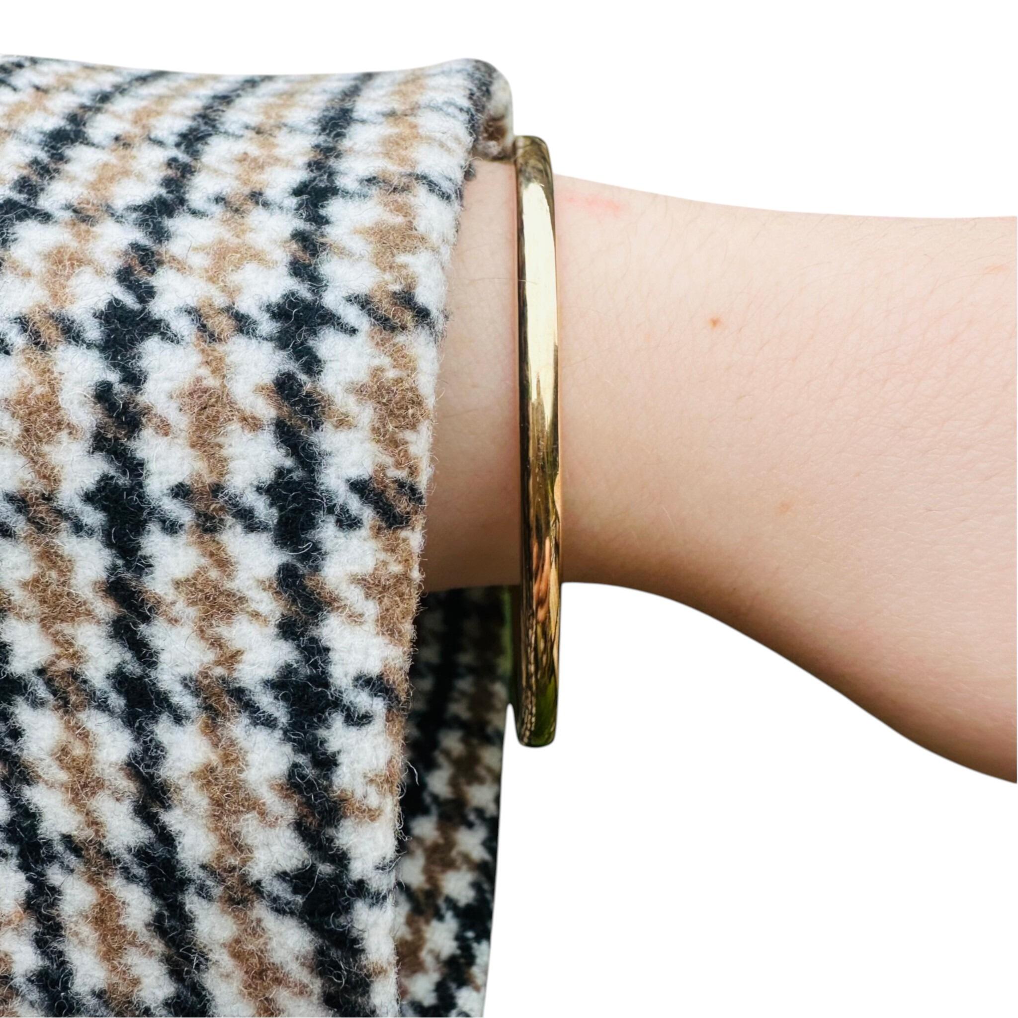 Vintage Solid Gold Bangle worn on models hand with white background