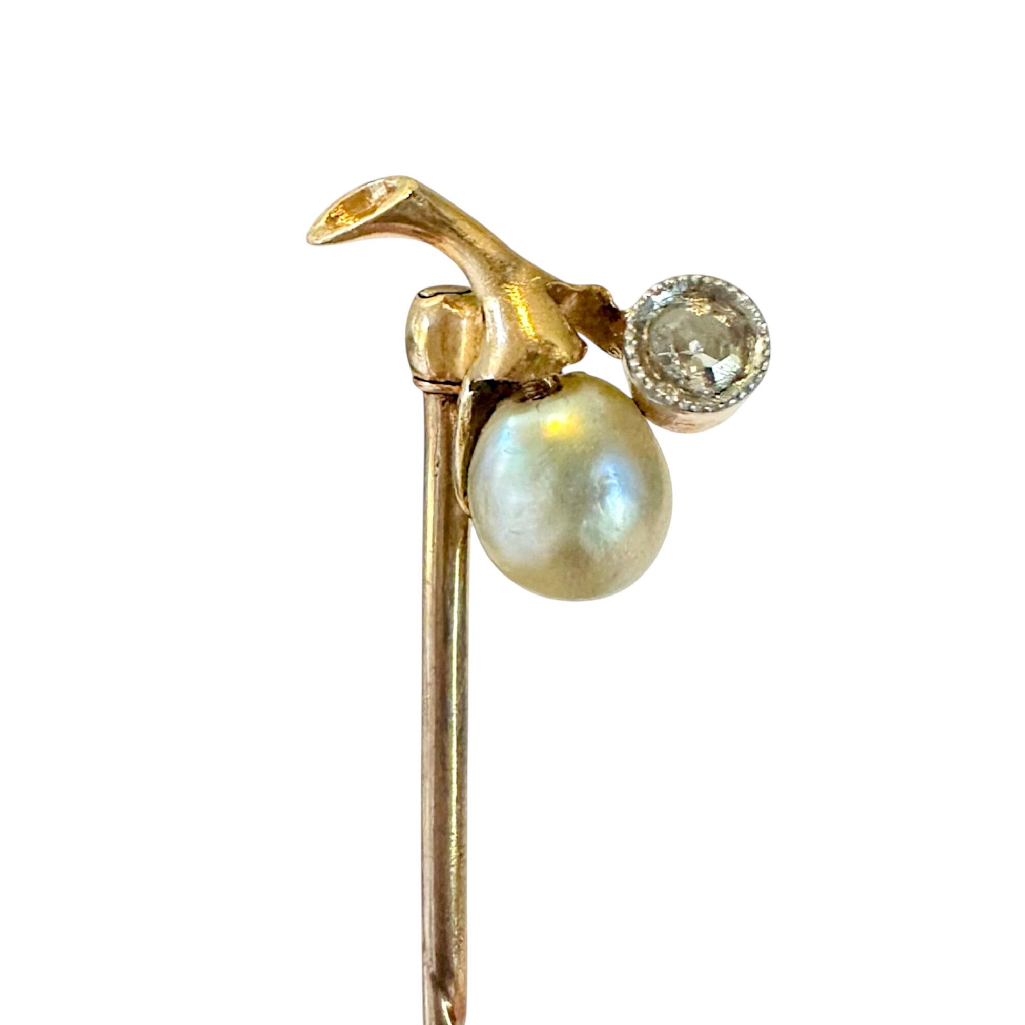 Art Nouveau stick pin in 15k gold with pear-shaped pearl and diamond berry design on white background.