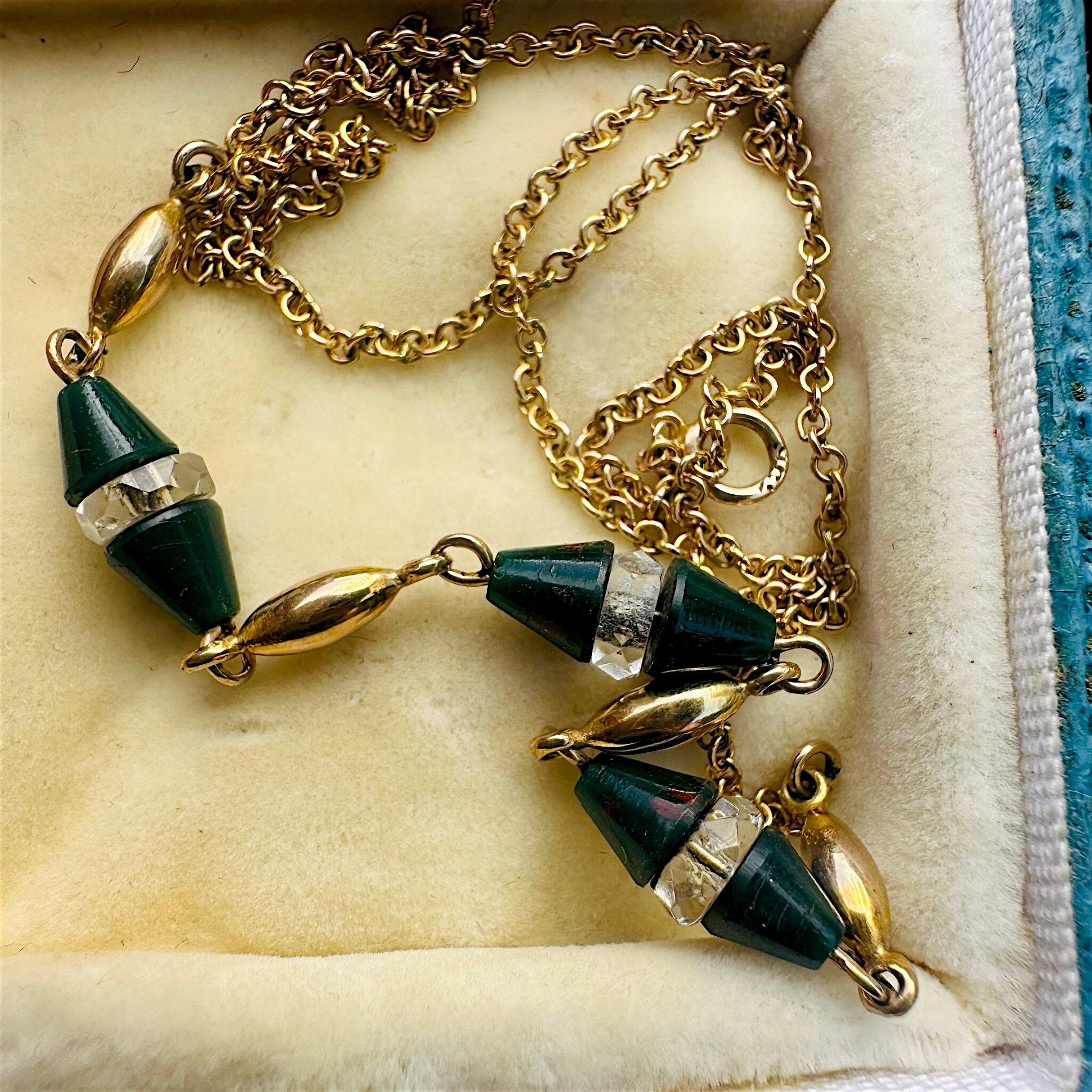 Antique Art Deco 9k Gold Bloodstone & Rock Crystal Bead Chain displayed laying on antique box
