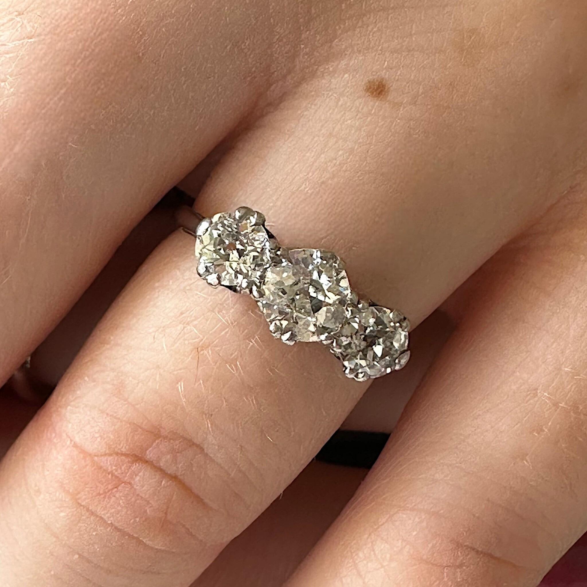 Antique Art Deco18K White Gold & Platinum, Old European Cut Diamond Trilogy Ring displayed on models hand