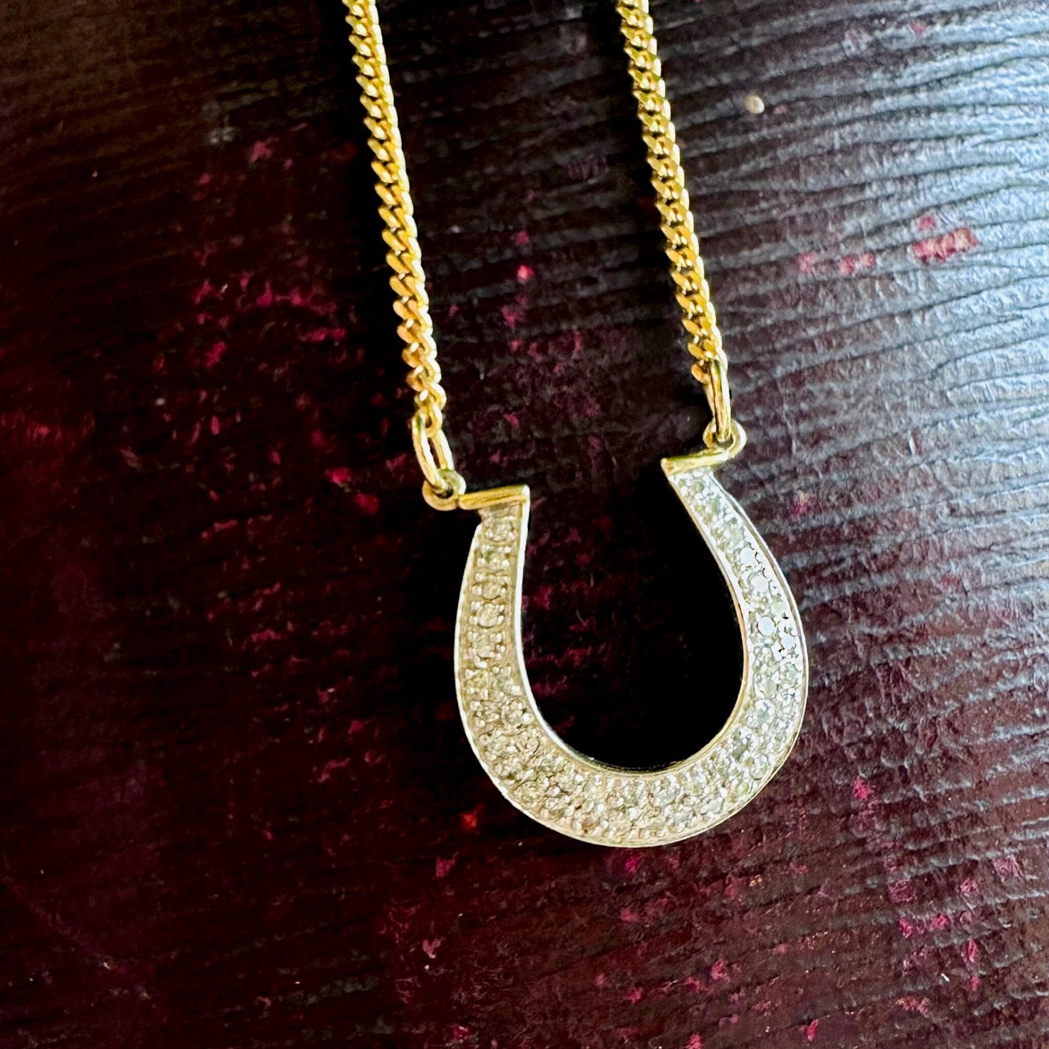 Vintage Diamond Horseshoe Necklace displayed on antique box