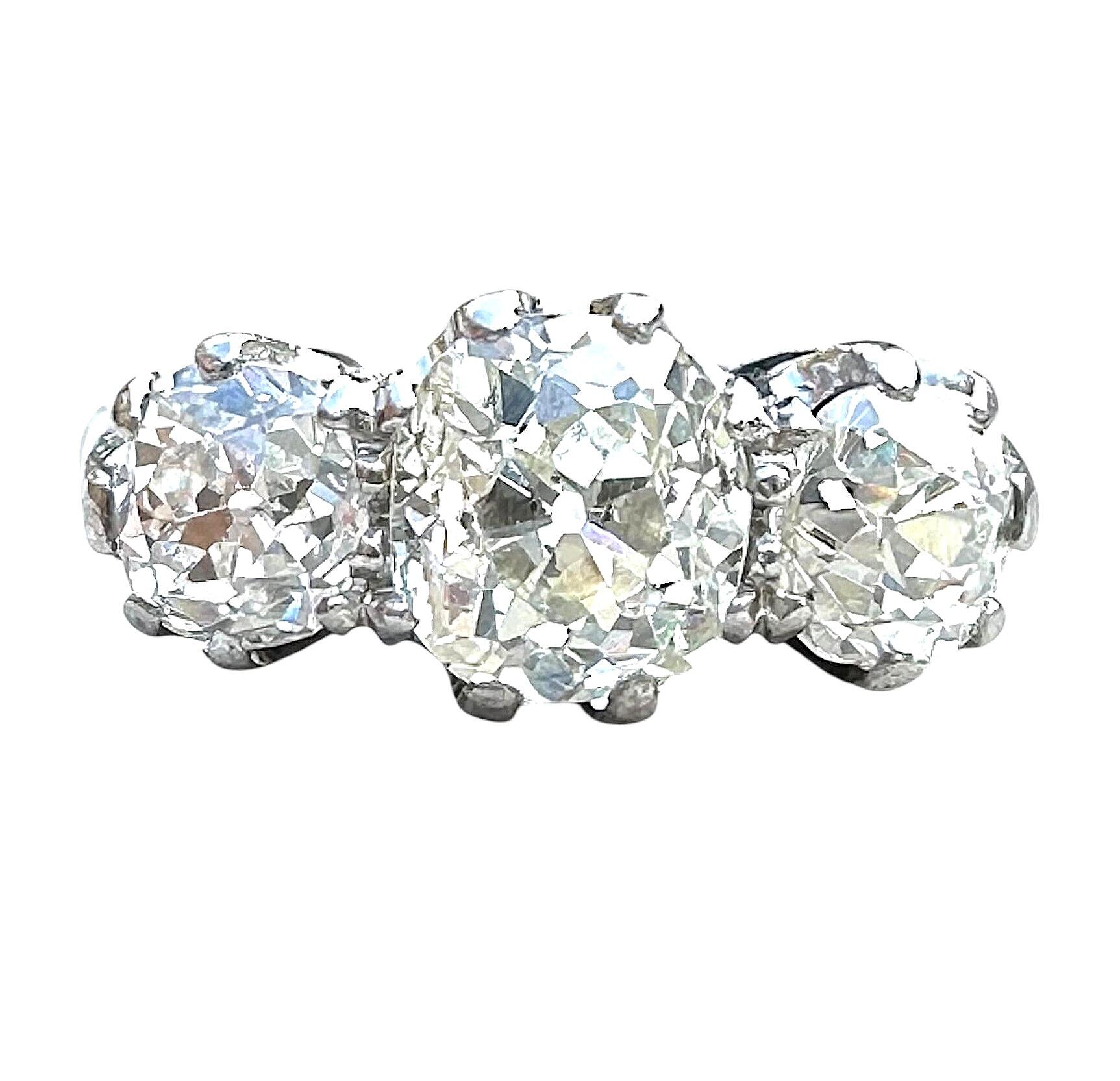 front view of Antique Platinum Old Cushion Cut Diamond Trilogy Ring with white background