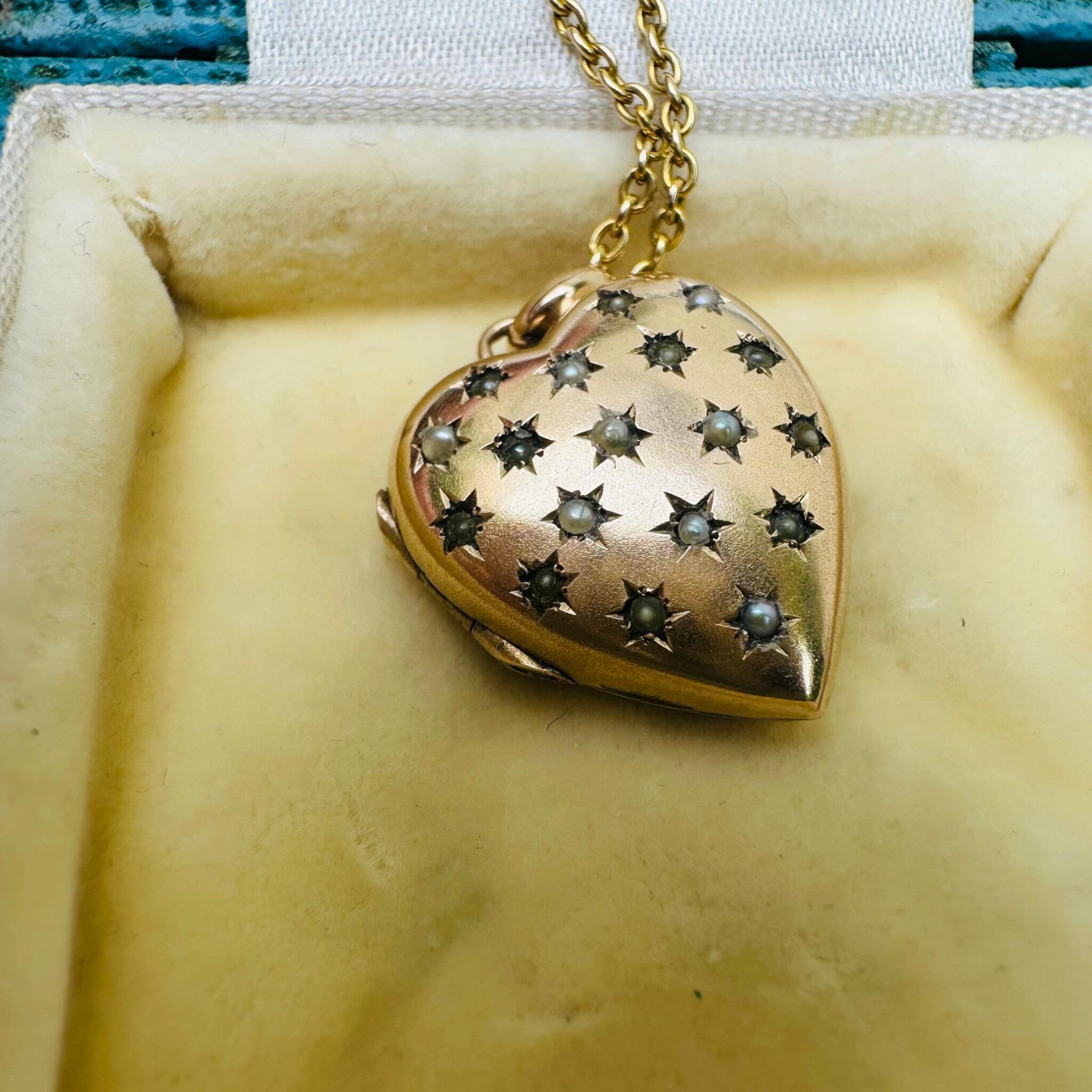 Vintage Gold Pearl Star Set Puffy Heart Locket displayed on antique box