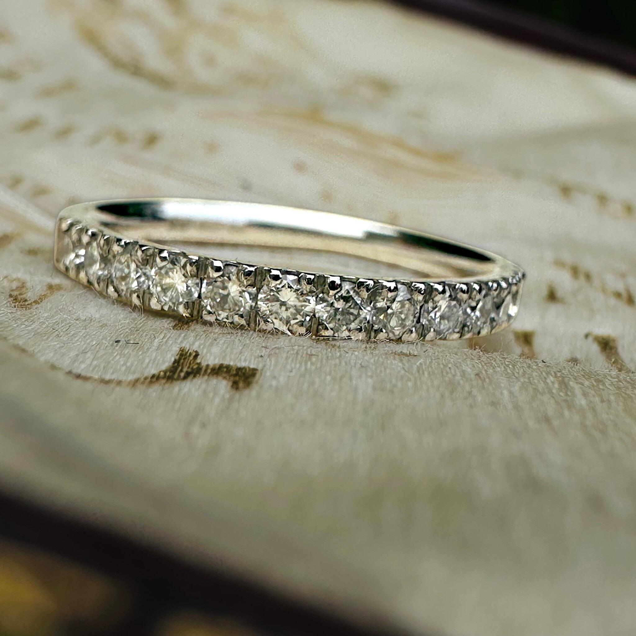 front view of Vintage Platinum & Diamond Band Ring displayed on antique box