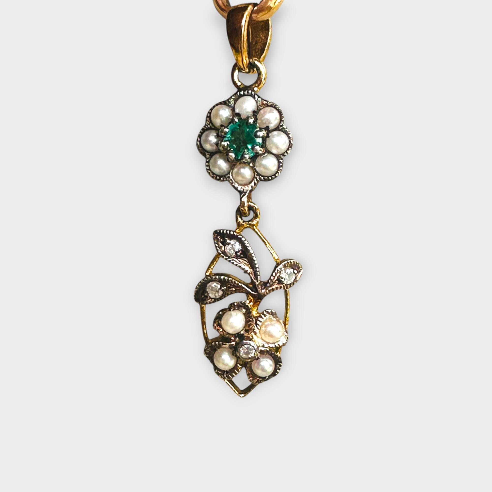 close up, Edwardian Style Emerald, Pearl & Diamond Pendant in Silver & 9k Gold with grey background.