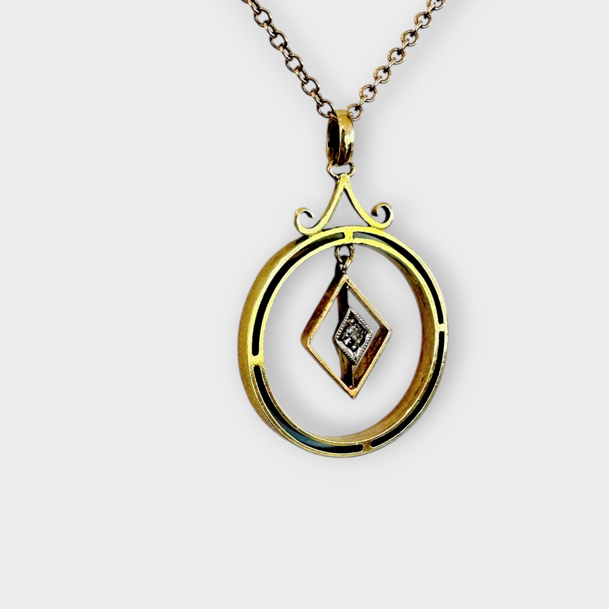 side view of Art Deco 15k gold pendant with central diamond and geometric design.
