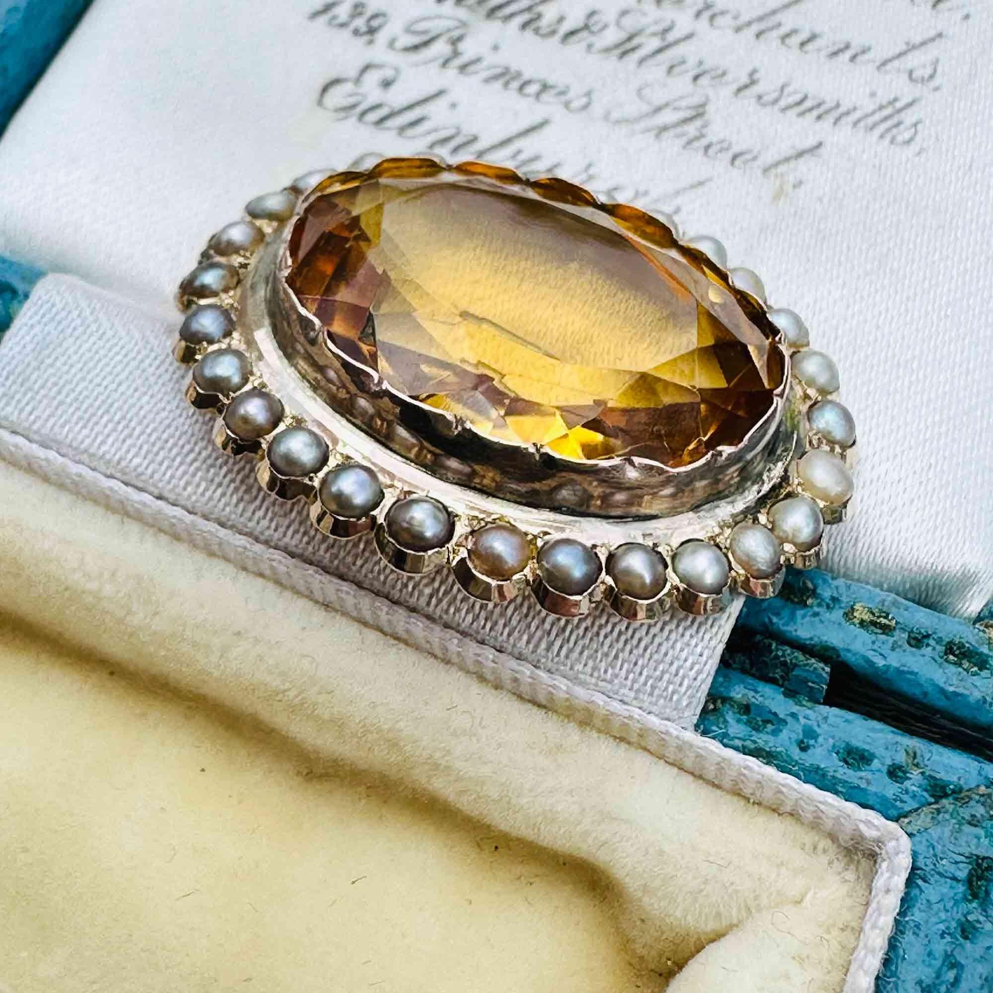 side view of Victorian citrine and pearl brooch in 9ct rose gold, displayed in antique box.