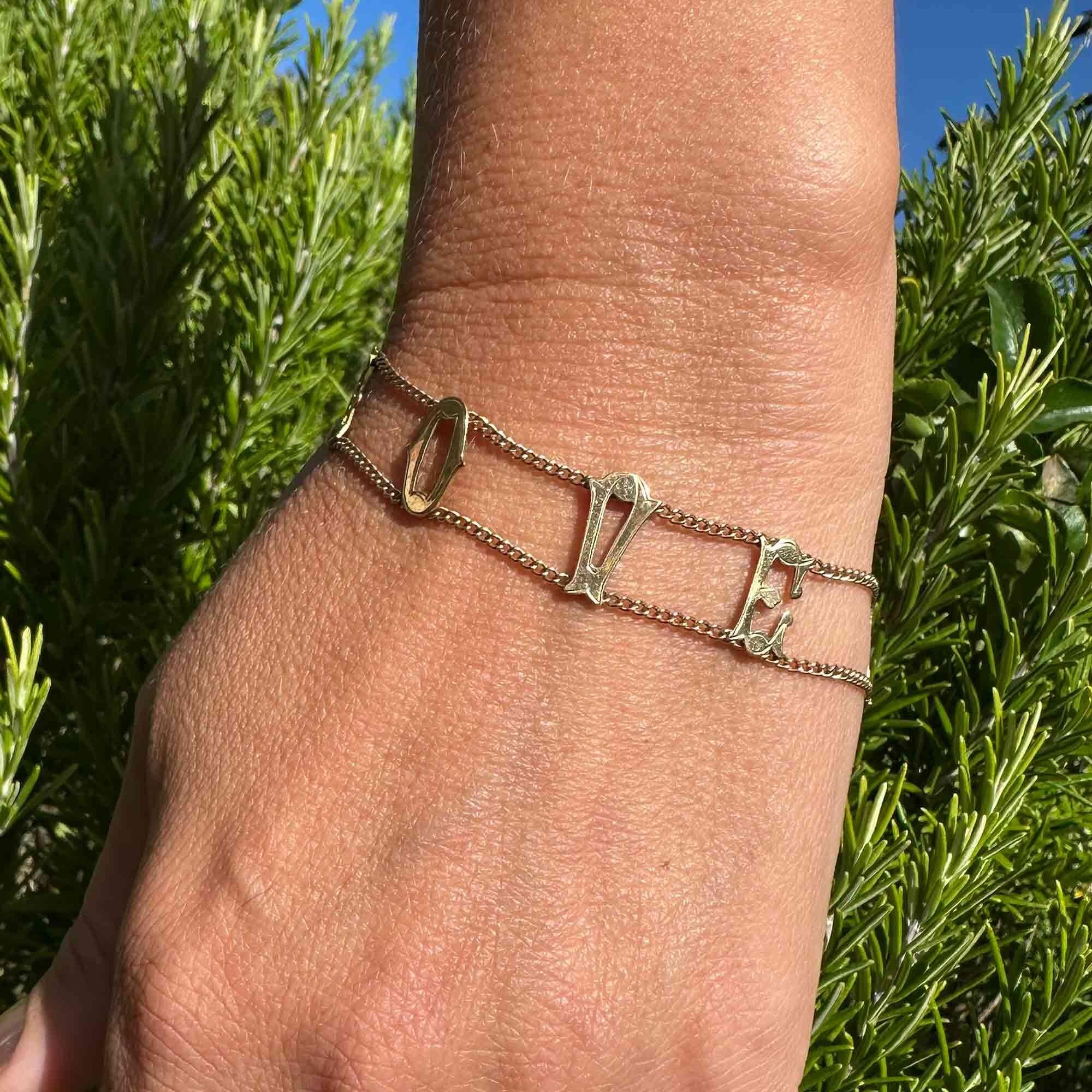 Vintage 9ct gold bracelet with "I Love You" links, on models wrist.