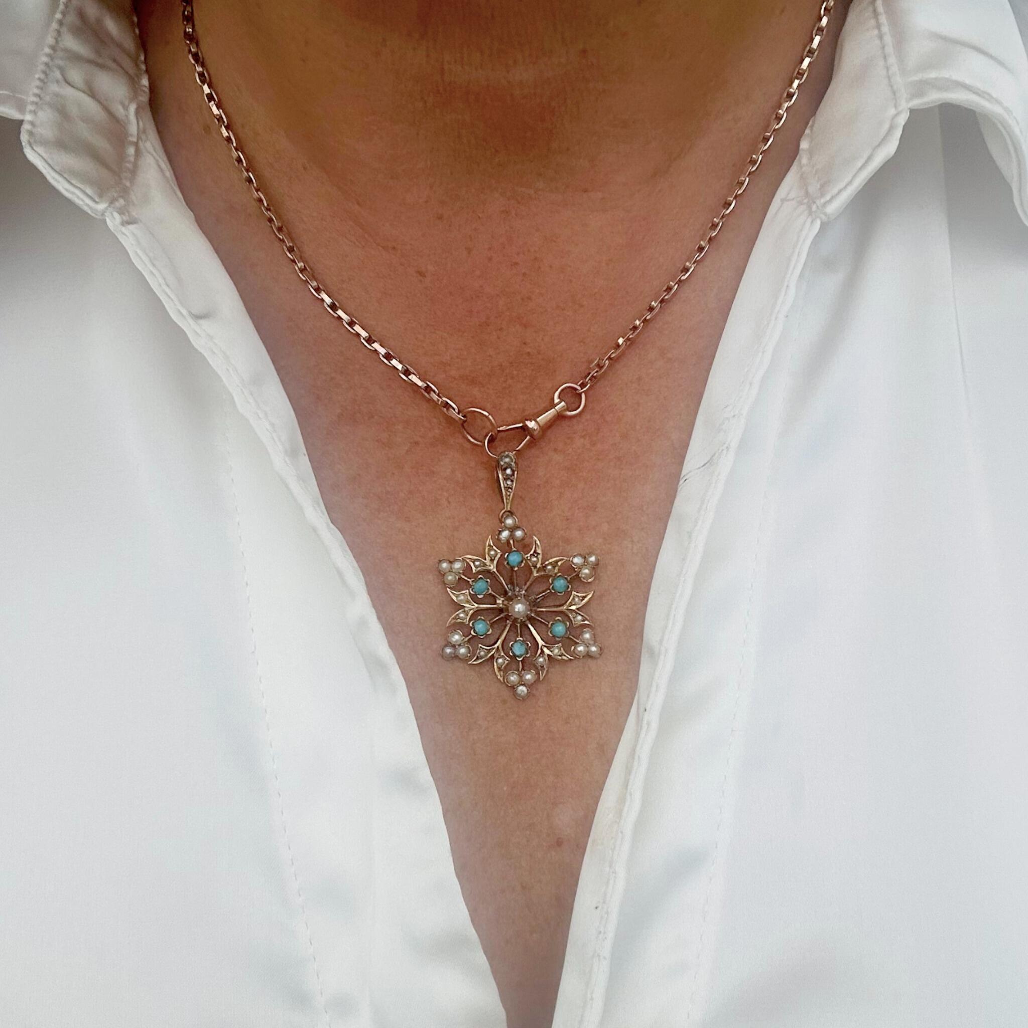 antique 9k gold Turquoise and pearl snowflake pendant on models neck