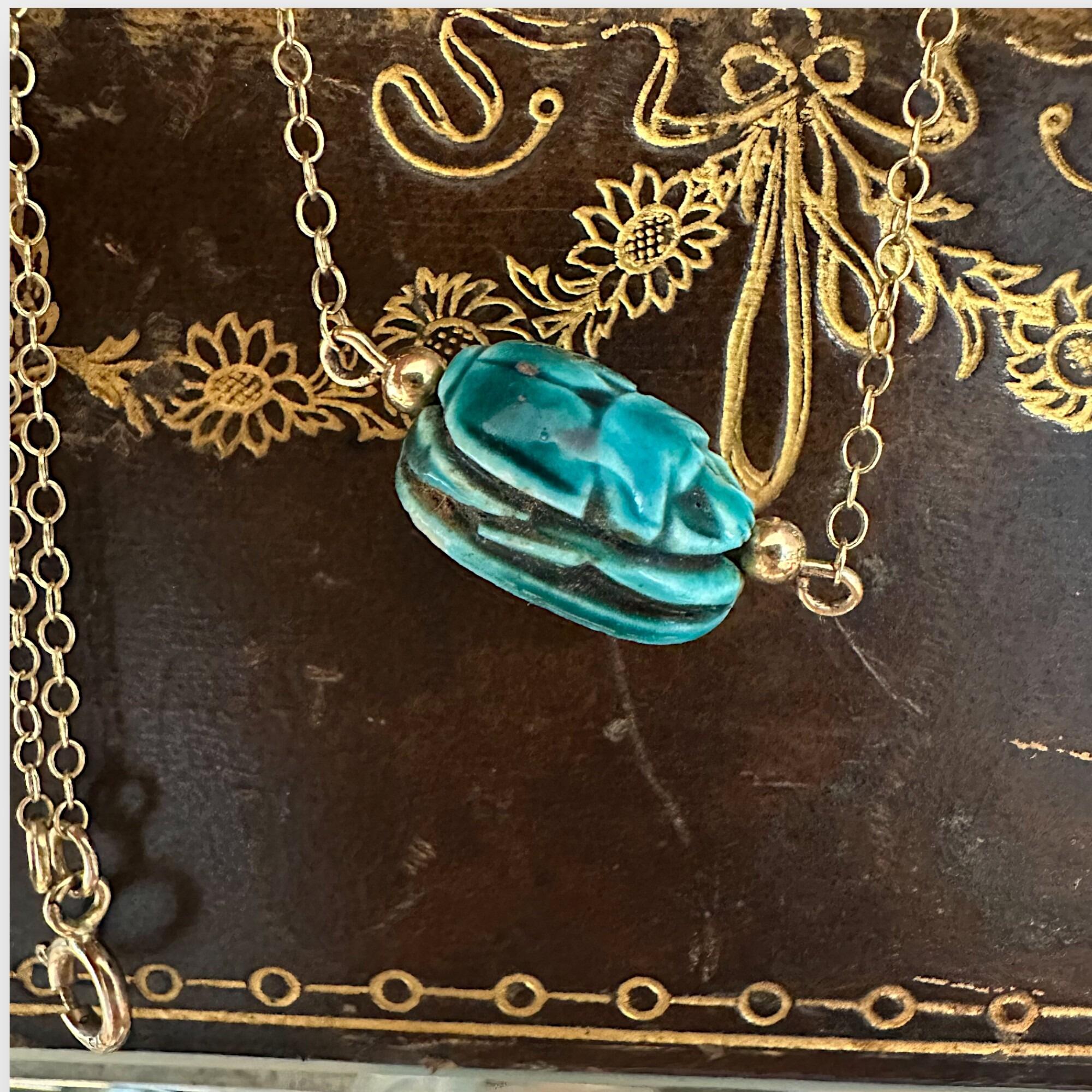9k Gold Blue Faience Scarab Necklace – Egyptian Revival Pendant displayed on antique box