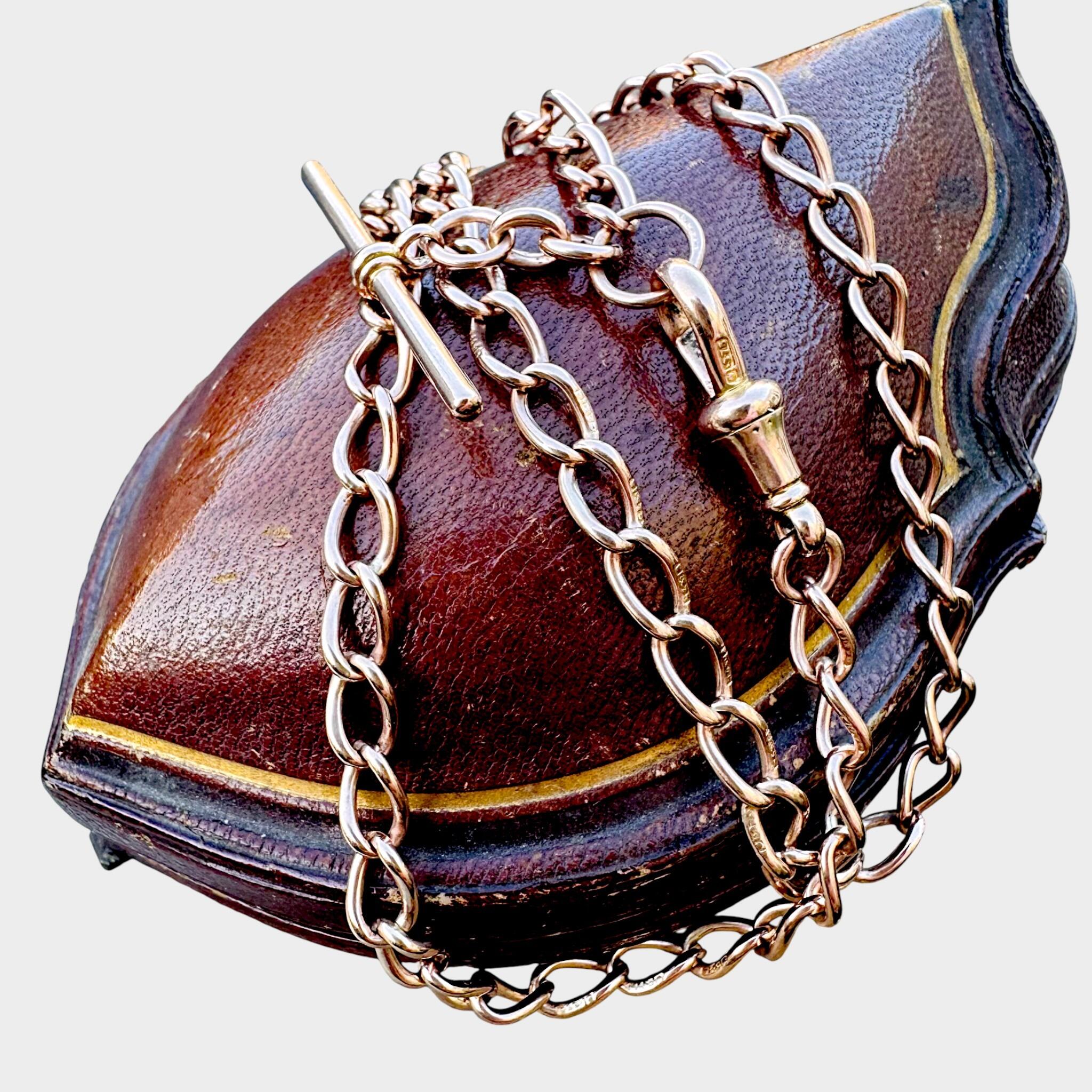 Rose Gold Curb Link Albert Chain With T-Bar & Dog Clip, displayed on antique box with grey background.