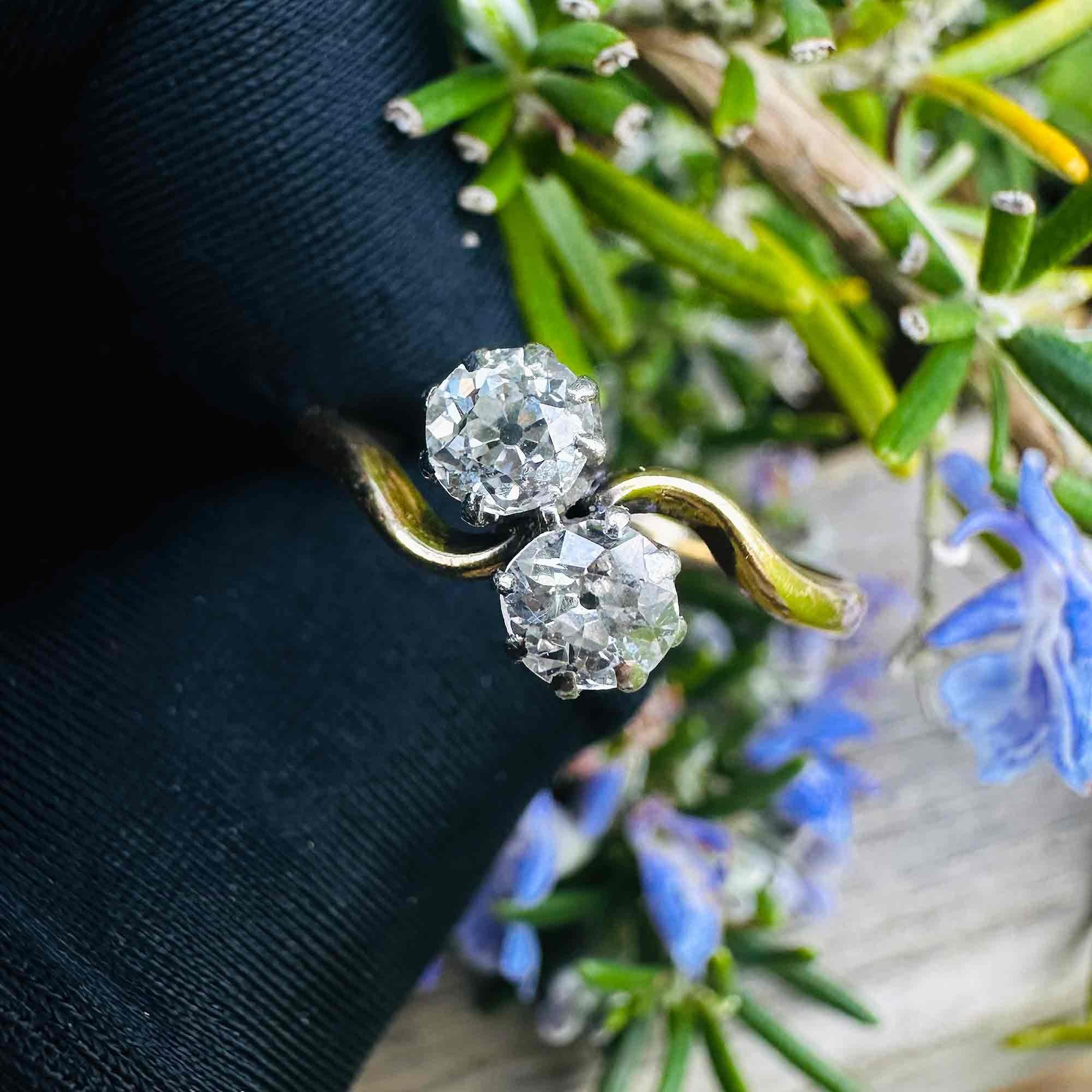 18ct Gold & Diamond Toi et Moi Ring held in black glove in garden