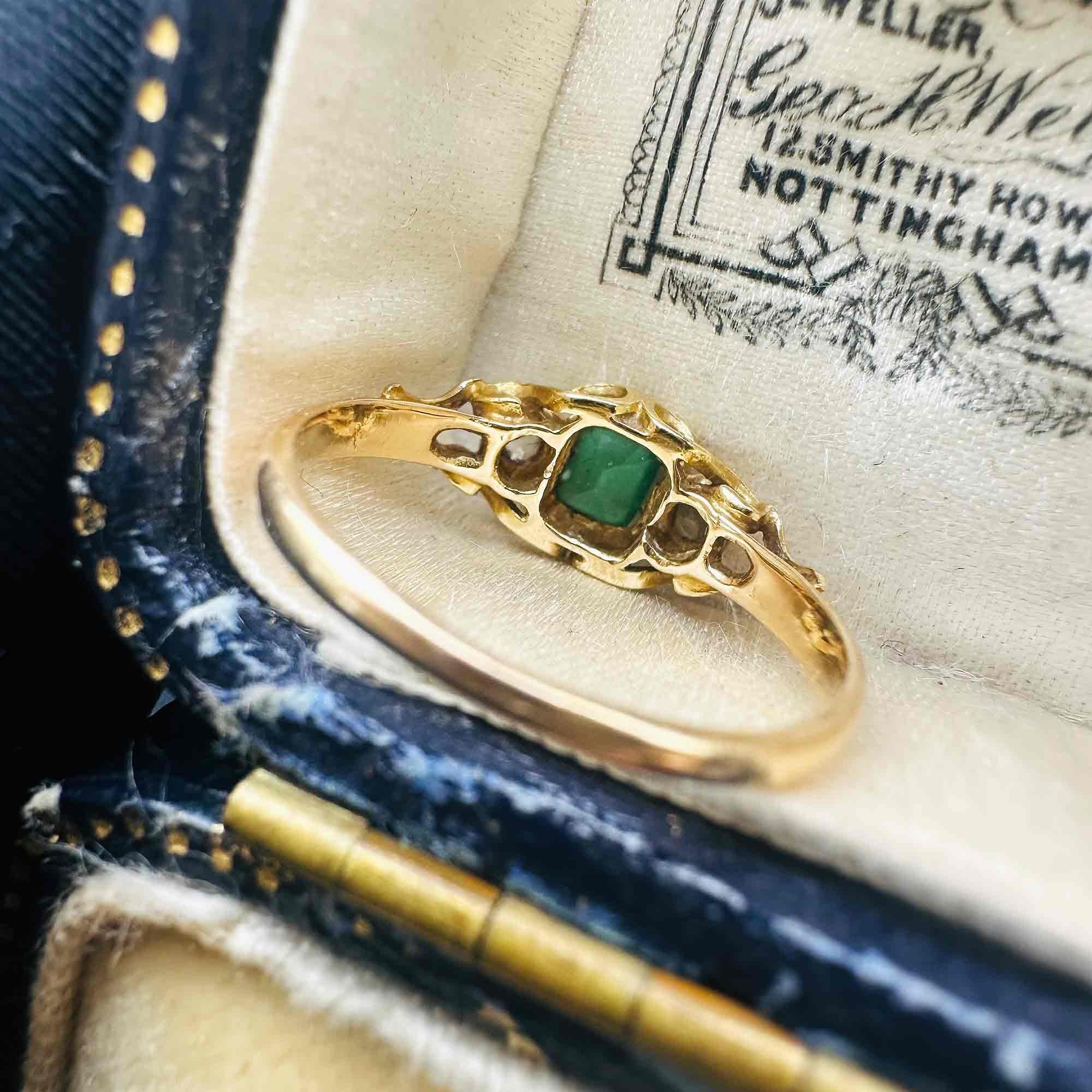 rear view of Emerald & Diamond Three Stone Victorian Ring displayed on antique box