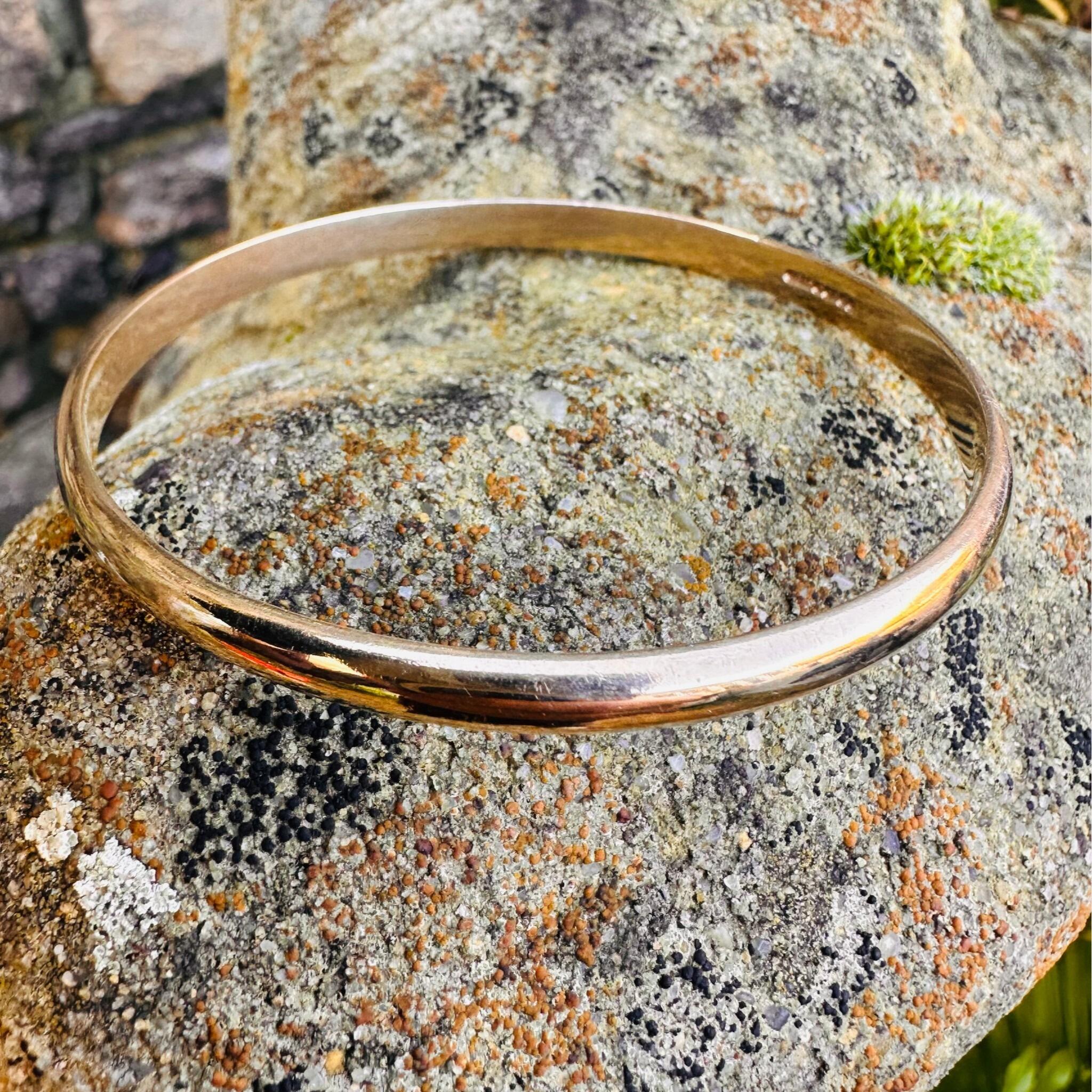 9ct Solid Gold D Shaped Bangle, Charles Green & Sons 1987 Hallmarked displayed on textured stone