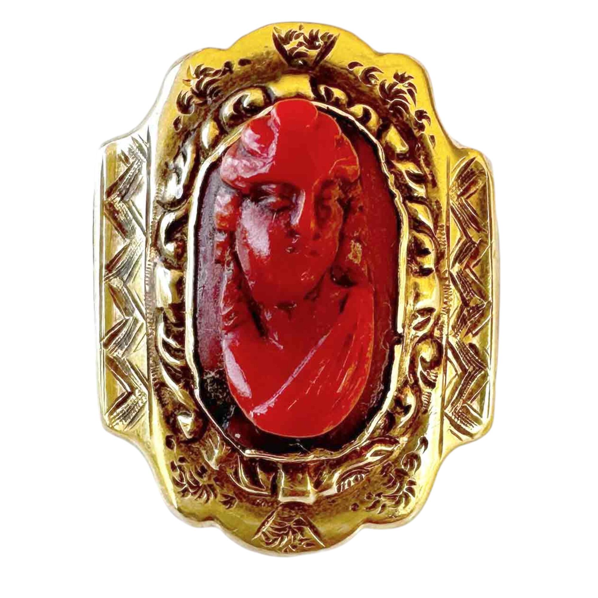 carved dark orange coral portrait brooch with gold decorative frame