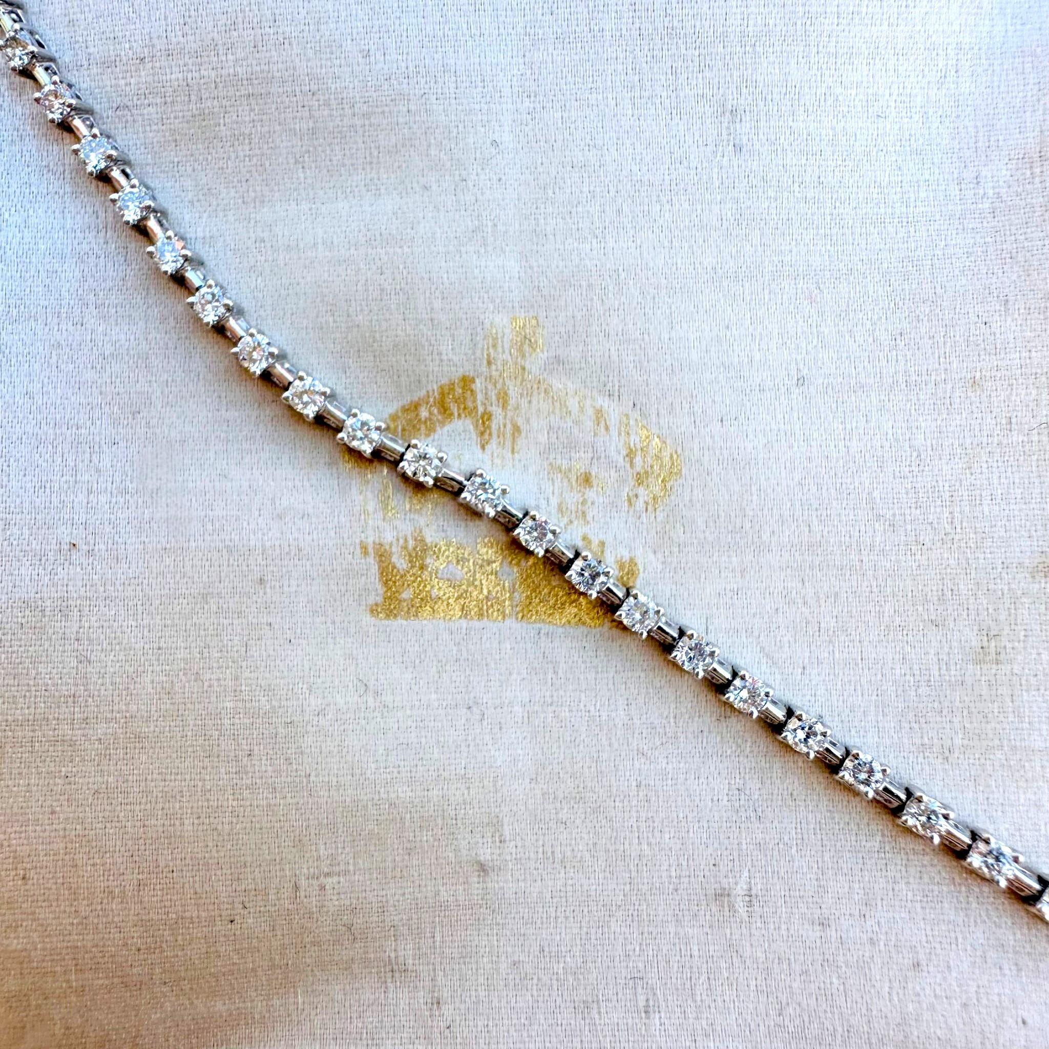 18K White Gold Diamond Tennis Bracelet laying on antique box