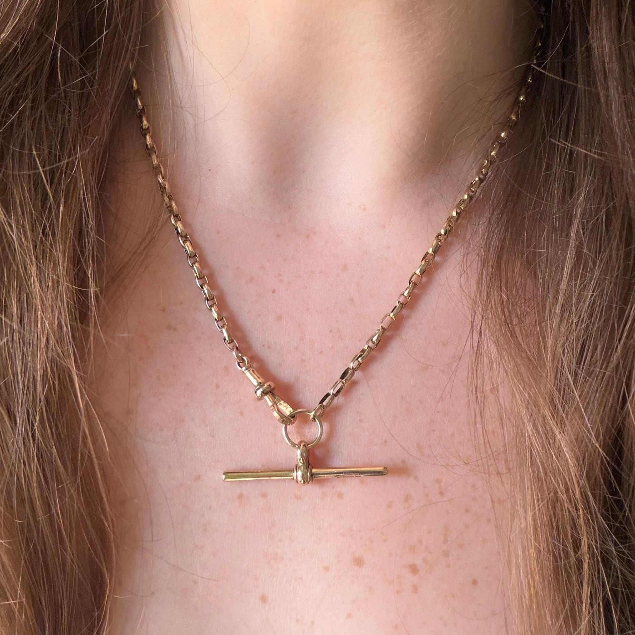 Victorian 9ct gold bike link chain necklace with faceted dog clip and T-bar clasp on models neck