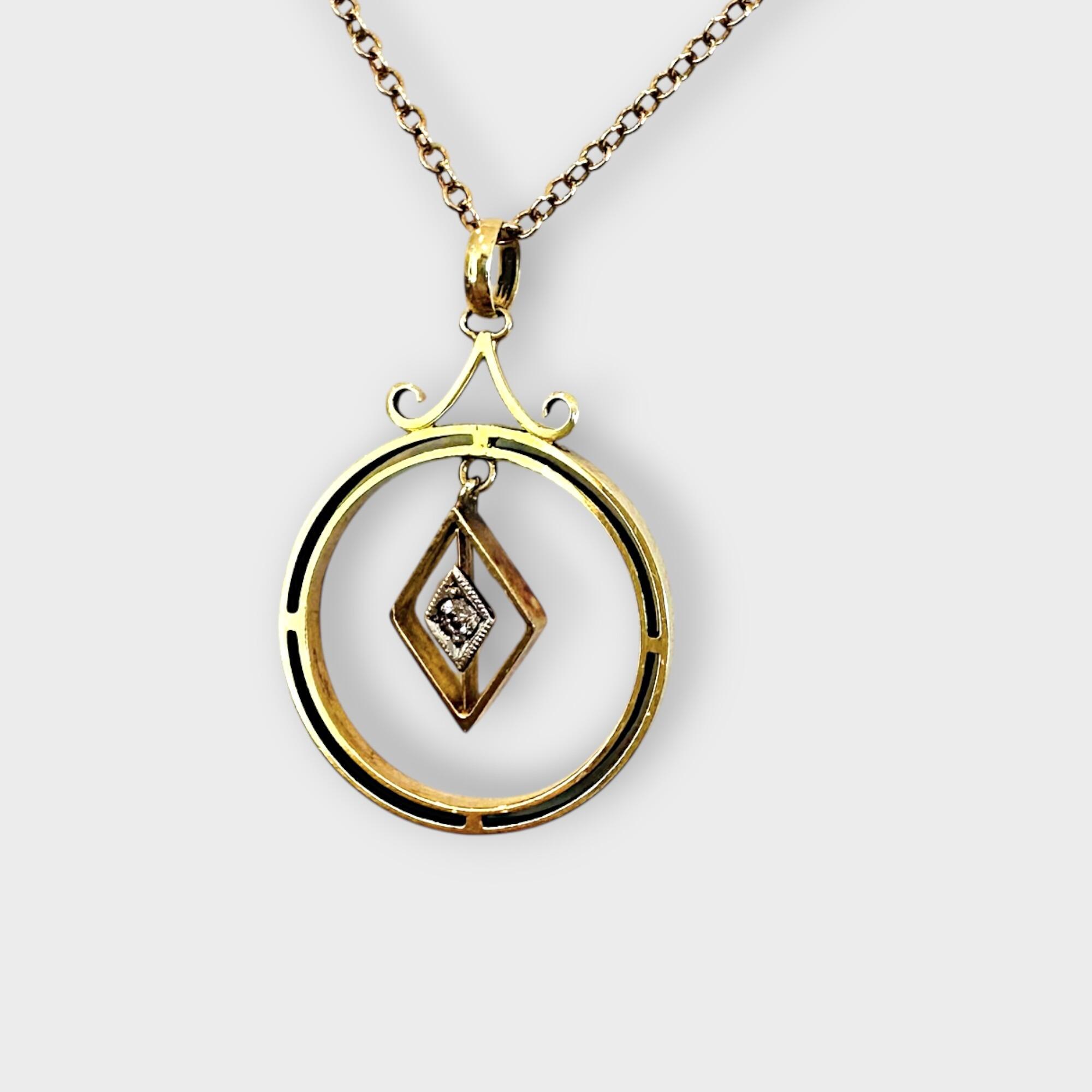 side view of Art Deco 15k gold pendant with central diamond and geometric design.