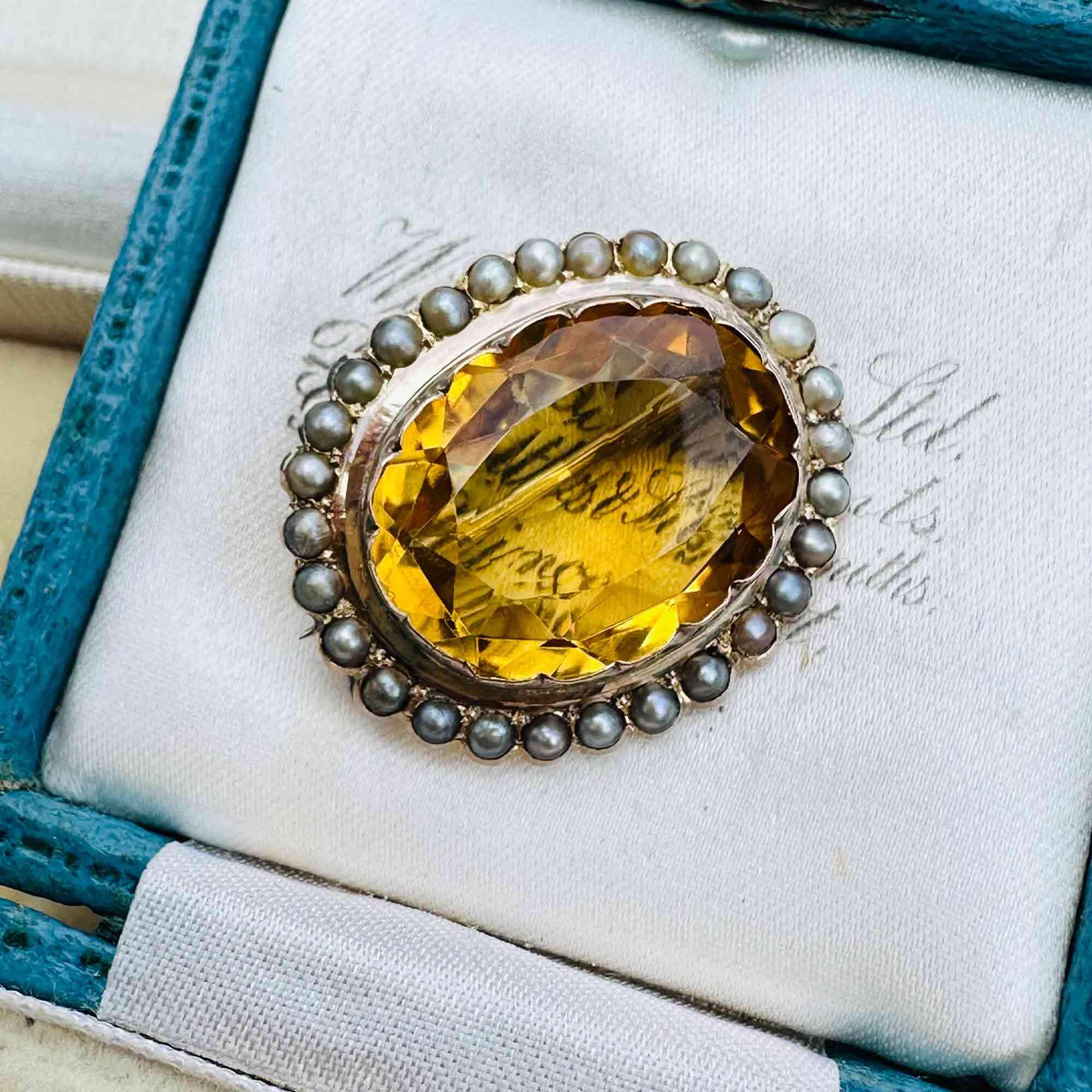 Front view of Victorian citrine and pearl brooch in 9ct rose gold, displayed in antique box.