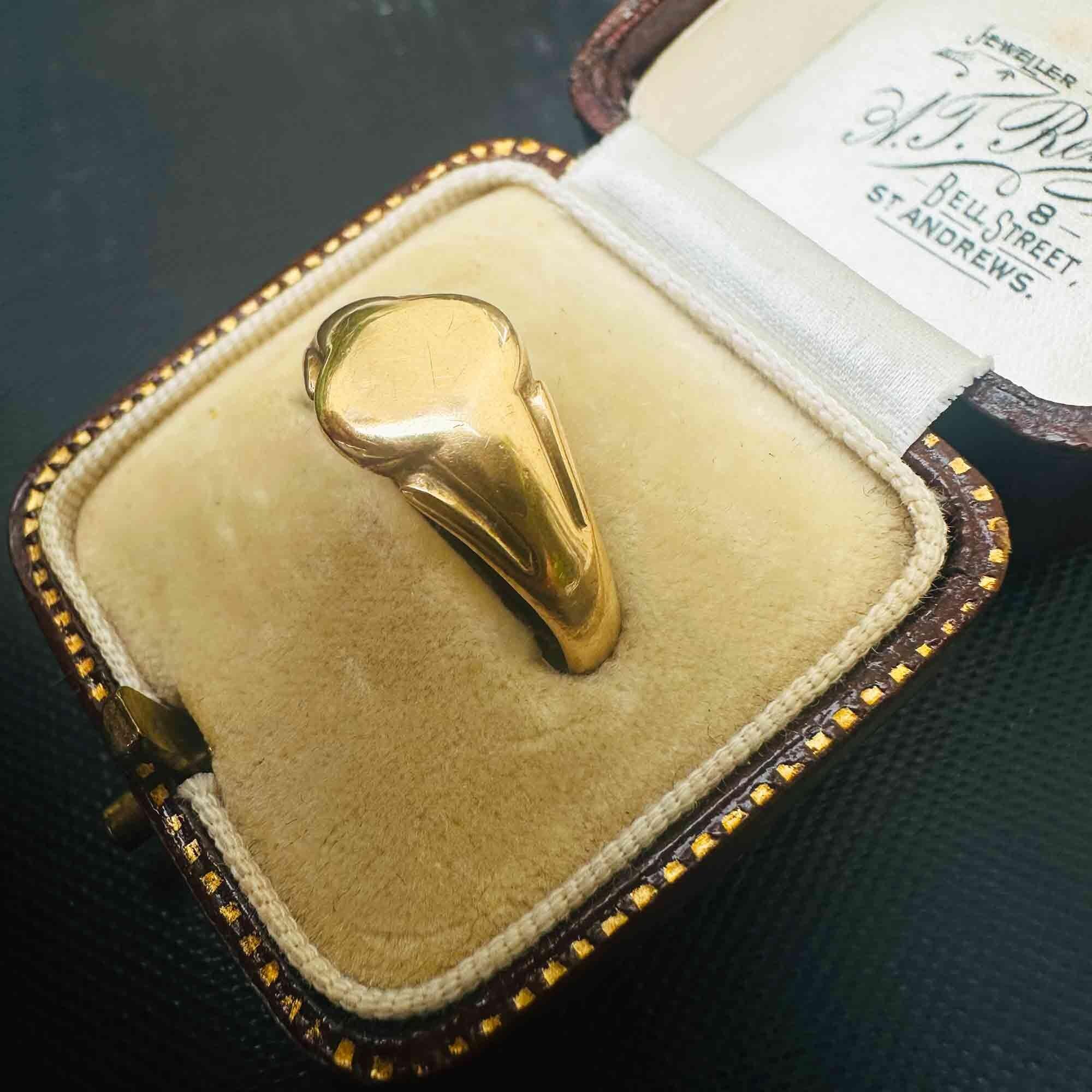 Side view of vintage 1942 18k yellow gold signet ring in antique box