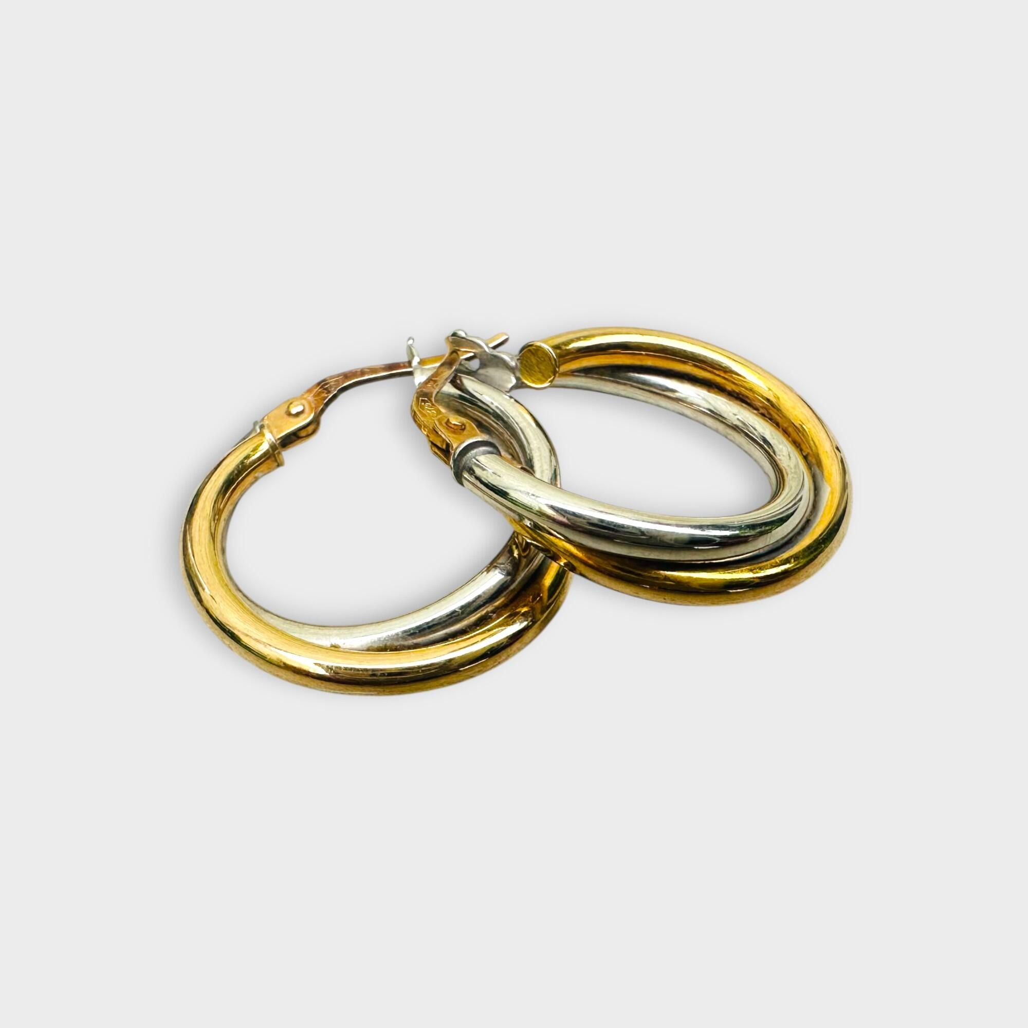 side view,Italian bi-colour 9k gold hoop earrings on grey background.