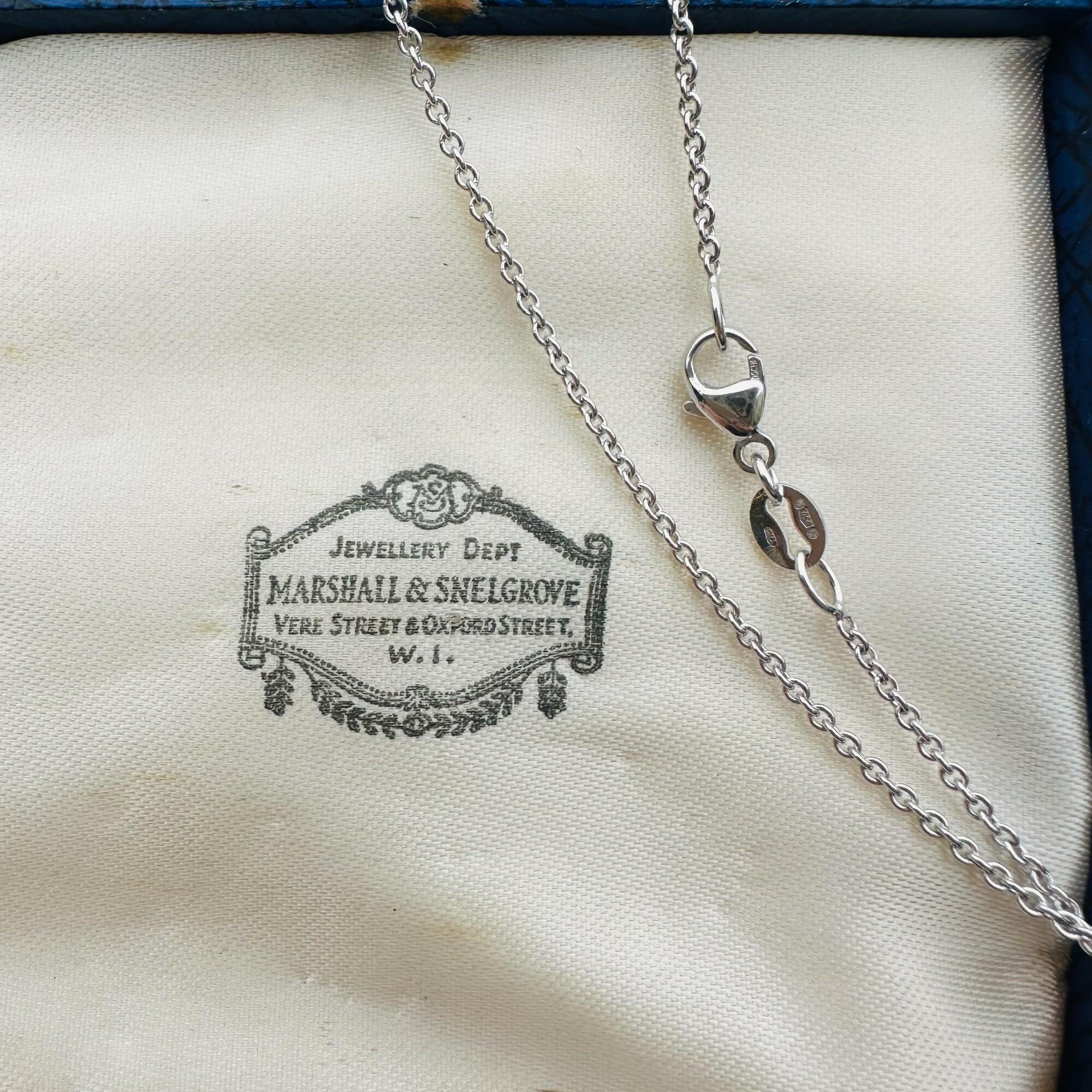platinum rolo chain on antique box, showing hallmarks.