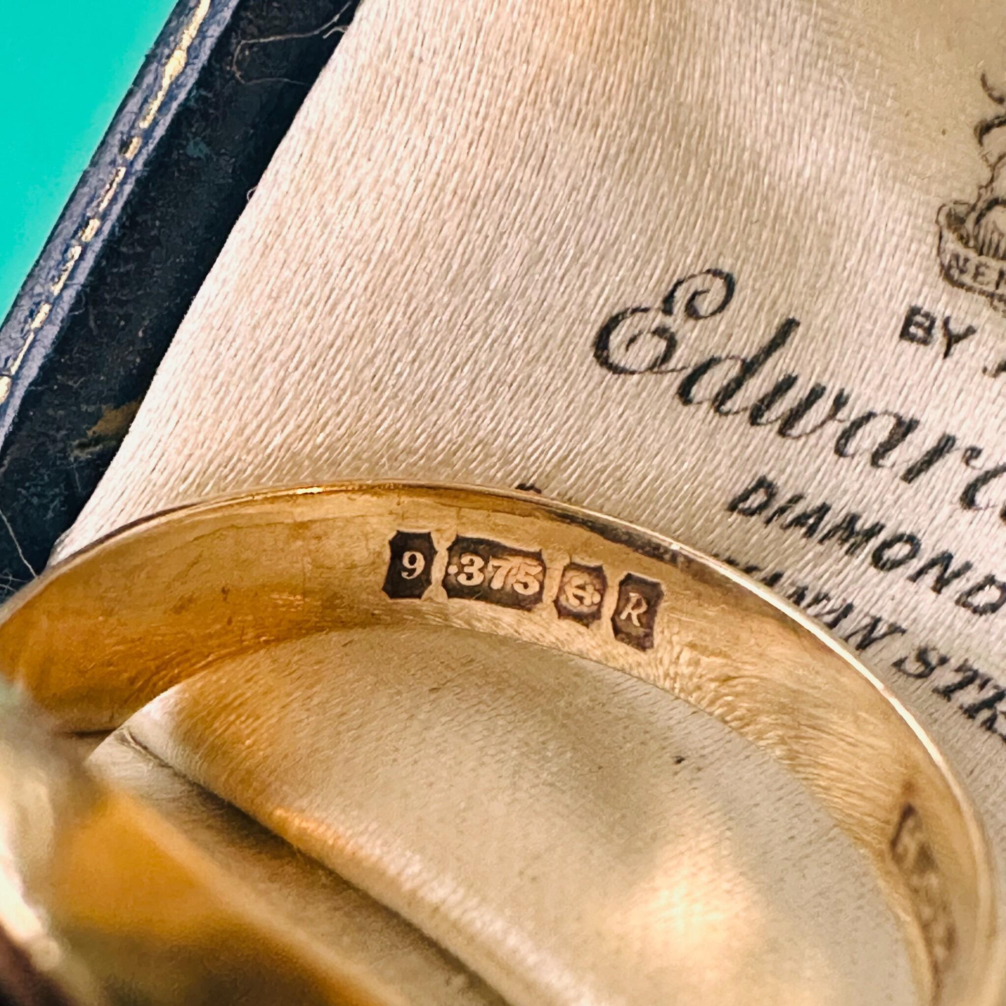 close up of Vintage, 9ct, 9k, 375 Gold Black Onyx signet ring, dated 1965, dated 1965, displayed in antique box.