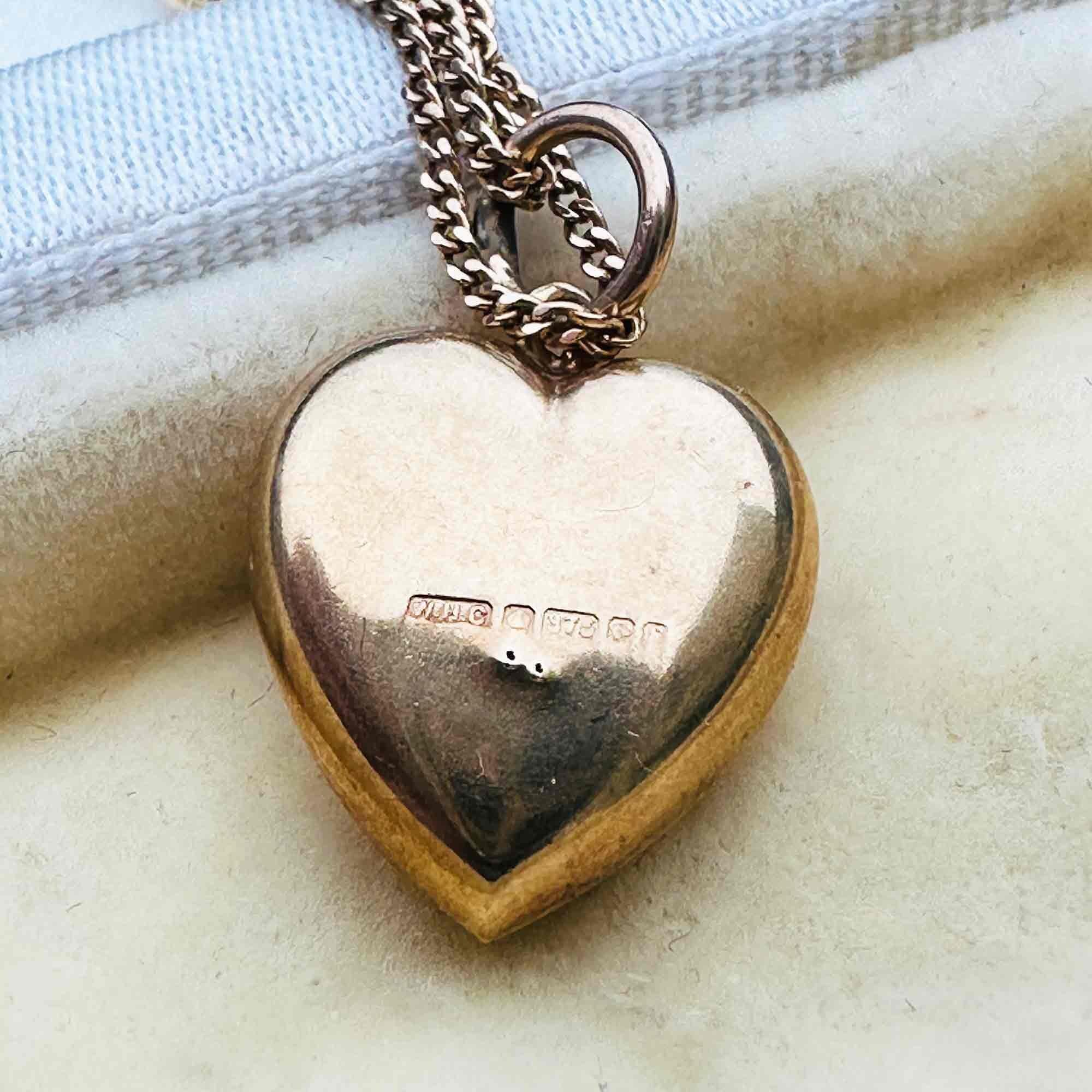 rear view of Gold Puffy Heart Necklace with Chain Dating 1942, displayed in a antique box.