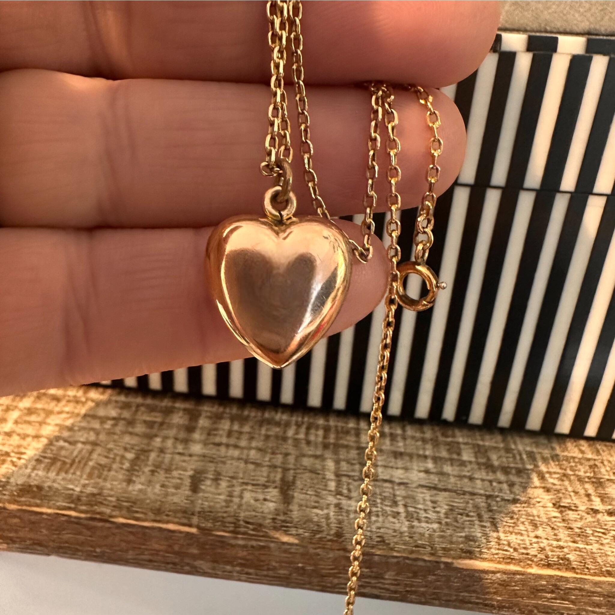 15ct Rose Gold Puffy Heart Pendant, held in hand