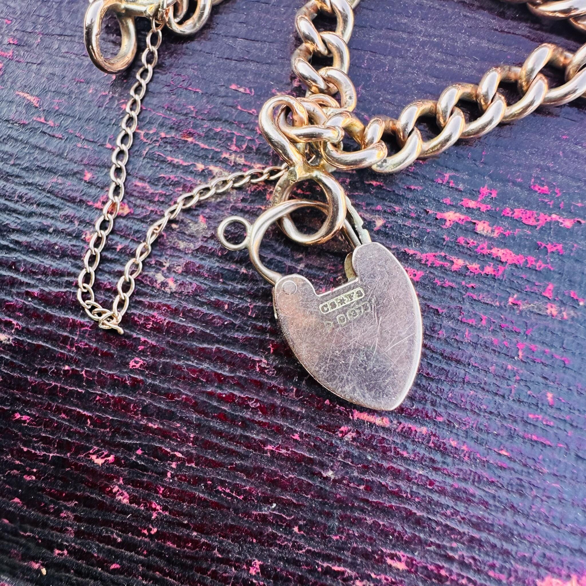 Rose Gold Double Curb Link Bracelet with Heart Padlock , displayed on antique box.